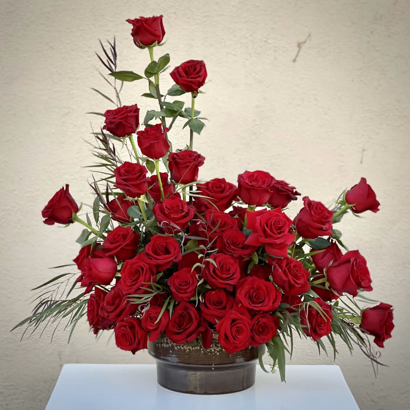 Bella Rosso - Pasadena Florist - Turn up the heat on a new romance - or a lifelong love affair - with this premium rose bouquet. 24 of the finest red Garden and Spray Roses are elegantly arranged in a stunning gold vase. It's simple, romantic, and breathtakingly gorgeous.  Deluxe: 36 roses   Premium: 48 roses 