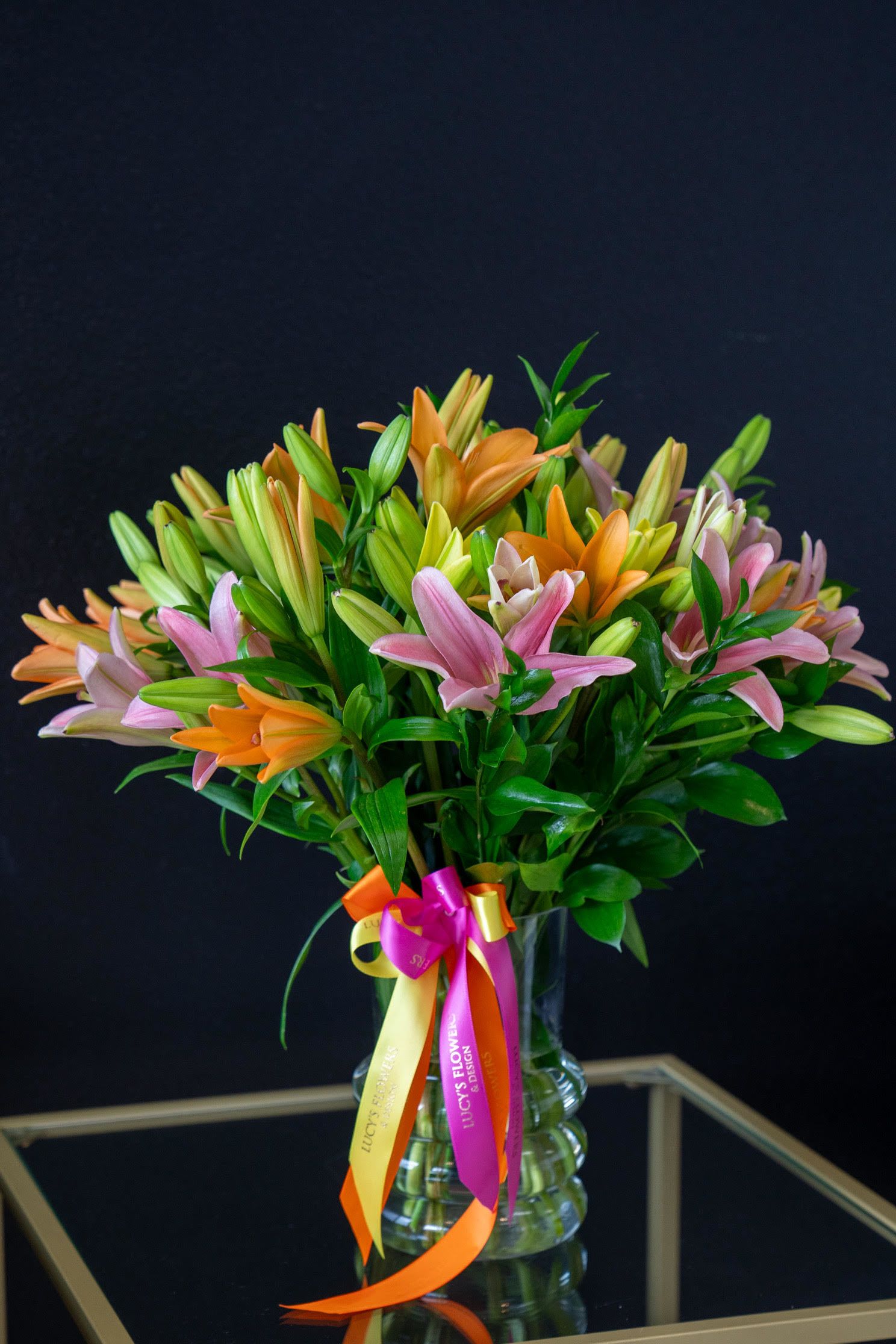 Lovely Lilies - Long-stemmed orange lilies, simply arranged in a clear glass vase, create a vivid presentation that will add a spot of color to any room. A lovely choice as a get well gift, a thank you offering, or for a business associate.