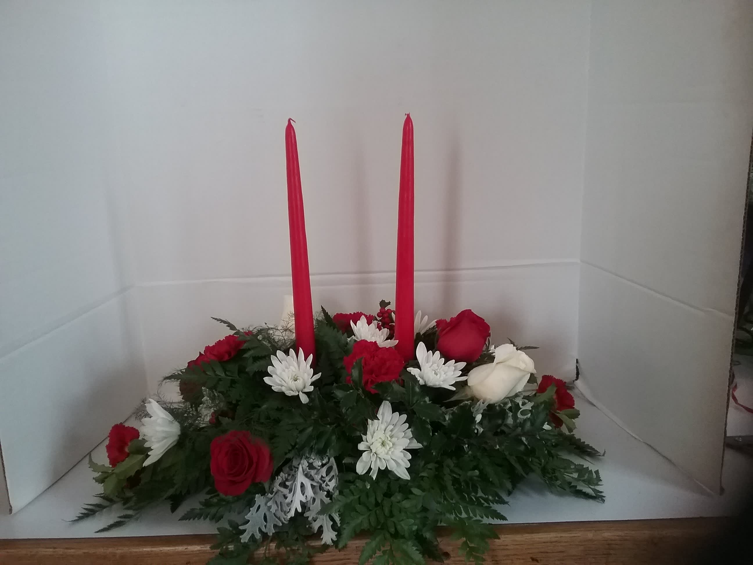2 Candle Centerpiece - Red roses and white cushion mums make this a stunning centerpiece for your holiday table. 