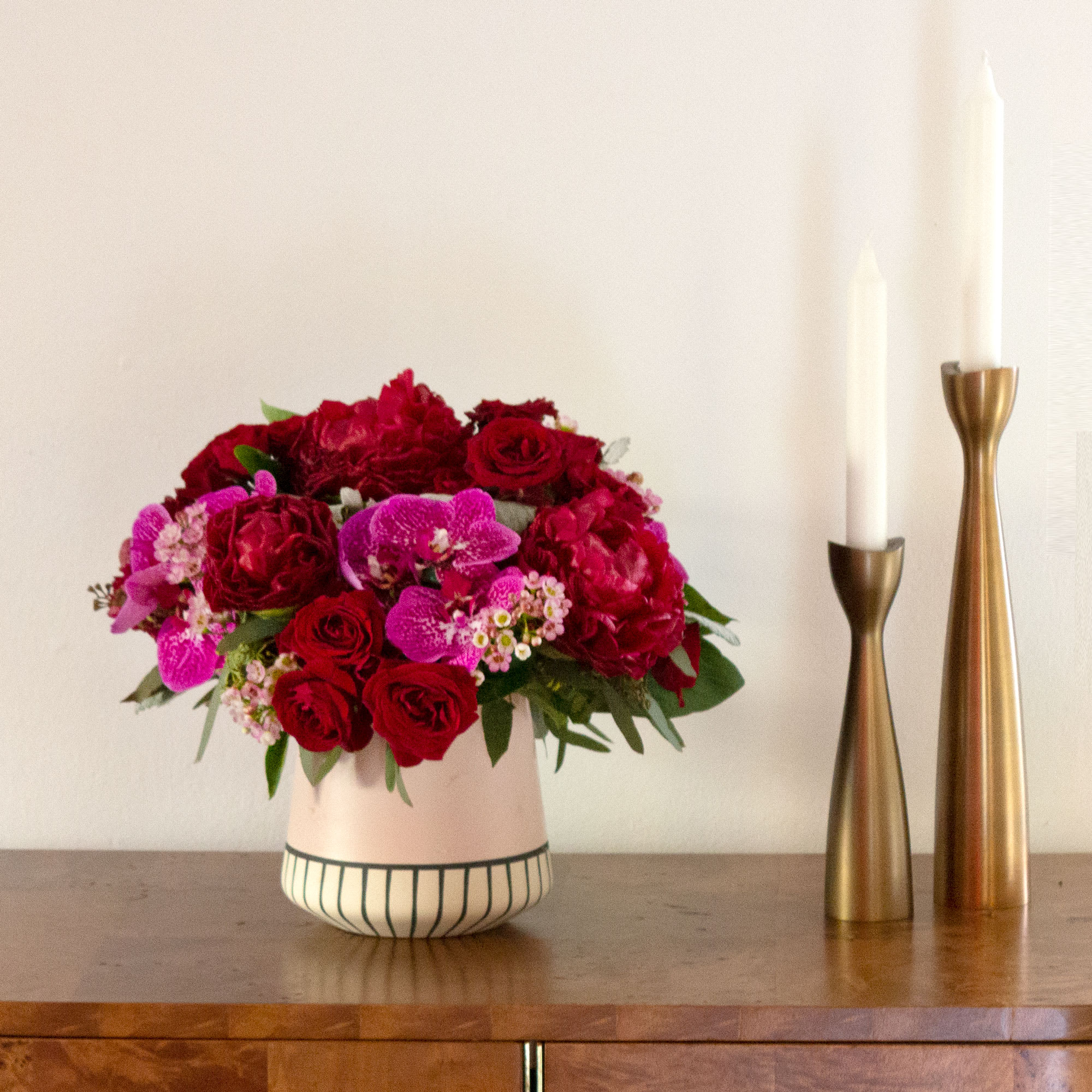 Red Dawn Red Dawn - This simple yet striking bouquet brings together scarlet Peonies and purple Phalaenopsis Orchids for a mix of love and romance they’ll remember always. Approx. 12" round