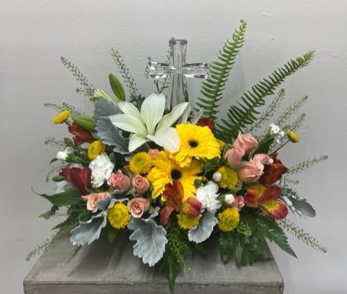 Autumn Petals Bouquet Autumn Petals Bouquet - This beautiful piece features autumn colored roses, Gerbera daisies, alstroemeria, white lilies, buttons with assorted greenery and filler with a crystal cross keepsake.