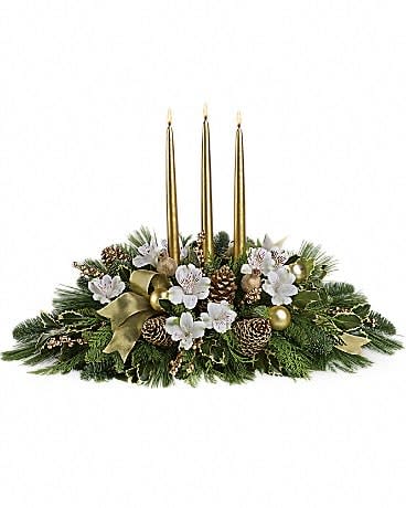 Royal Christmas Centerpiece - Know someone who deserves the royal treatment this holiday season? This shimmering golden centerpiece will shine its golden light upon them. Three gorgeous gold taper candles take center stage in an arrangement of crÃ¨me roses and spray roses, white alstroemeria, gold ornaments, pinecones, intricate mesh ribbon, Christmas greenery and more. This kind of high style really is fit for a king or queen!
