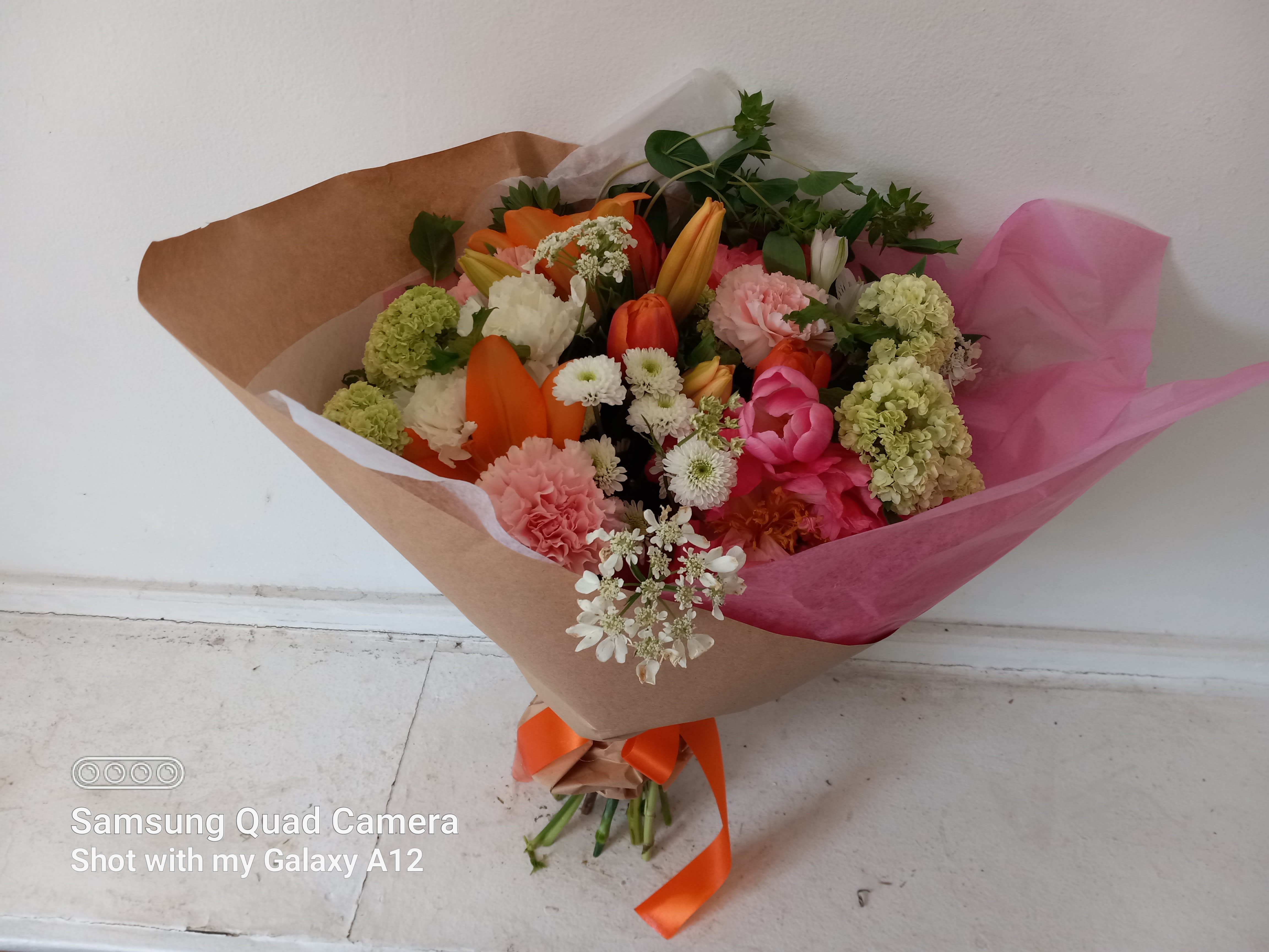 Jordan - Beautiful blush &amp; orange/.pink mix of peach peonies, orange lilies, pink and white carnations and orange tulips with vibrum brunches hend tied bouquet