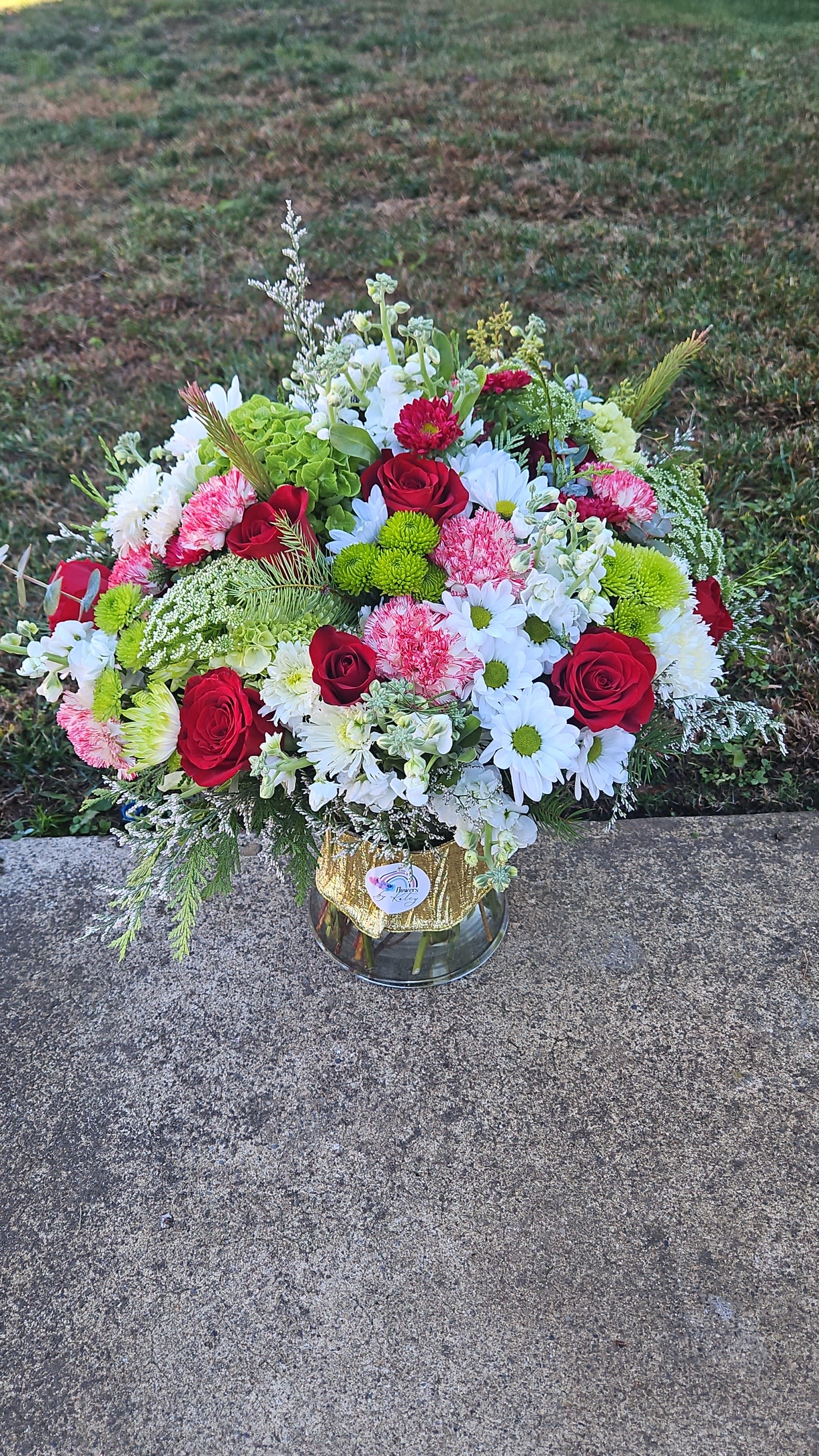 Katey's Christmas Magic Katey's Christmas Magic - The freshest flowers in season with a Christmas twist and perfectly arranged in a vase.