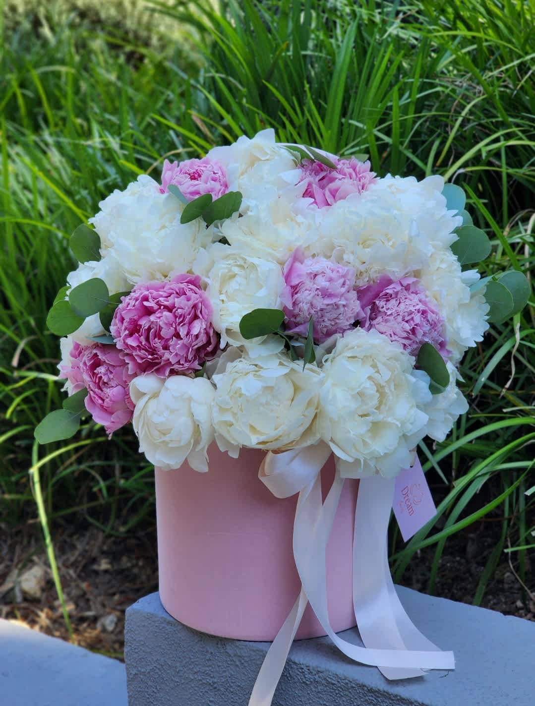 Season Peonies  - Indulge in the charm of our pink and white peonies, nestled within exquisite hatboxes, and embrace the enchantment as the floral magic unfolds – because every moment deserves to be adorned with the beauty of fresh blossoms.  RECOMMENDED FOR: Love and Romance, I Love You Flowers, Anniversary, Proposal,  Romantic Gift, Birthday, Get Well Soon, Celebrations, Best Wishes, Thank You, Congratulations, Just Because, New Baby, Everyday