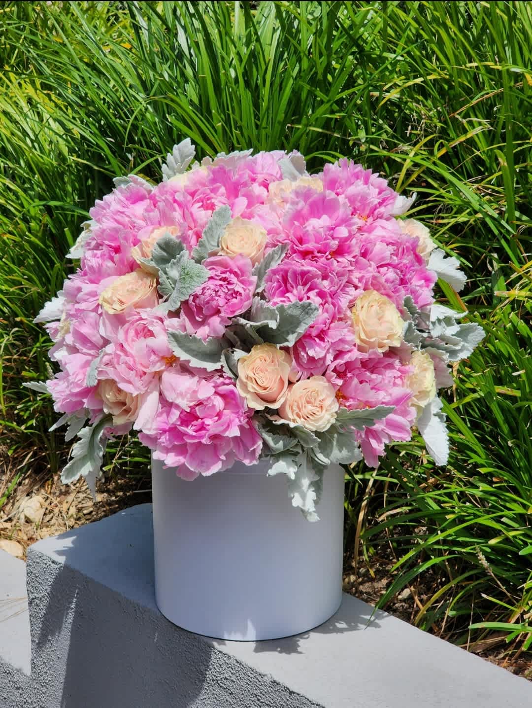Love is... - Indulge in the charm of our pink peonies, nestled within exquisite hatboxes, and embrace the enchantment as the floral magic unfolds – because every moment deserves to be adorned with the beauty of fresh blossoms.  