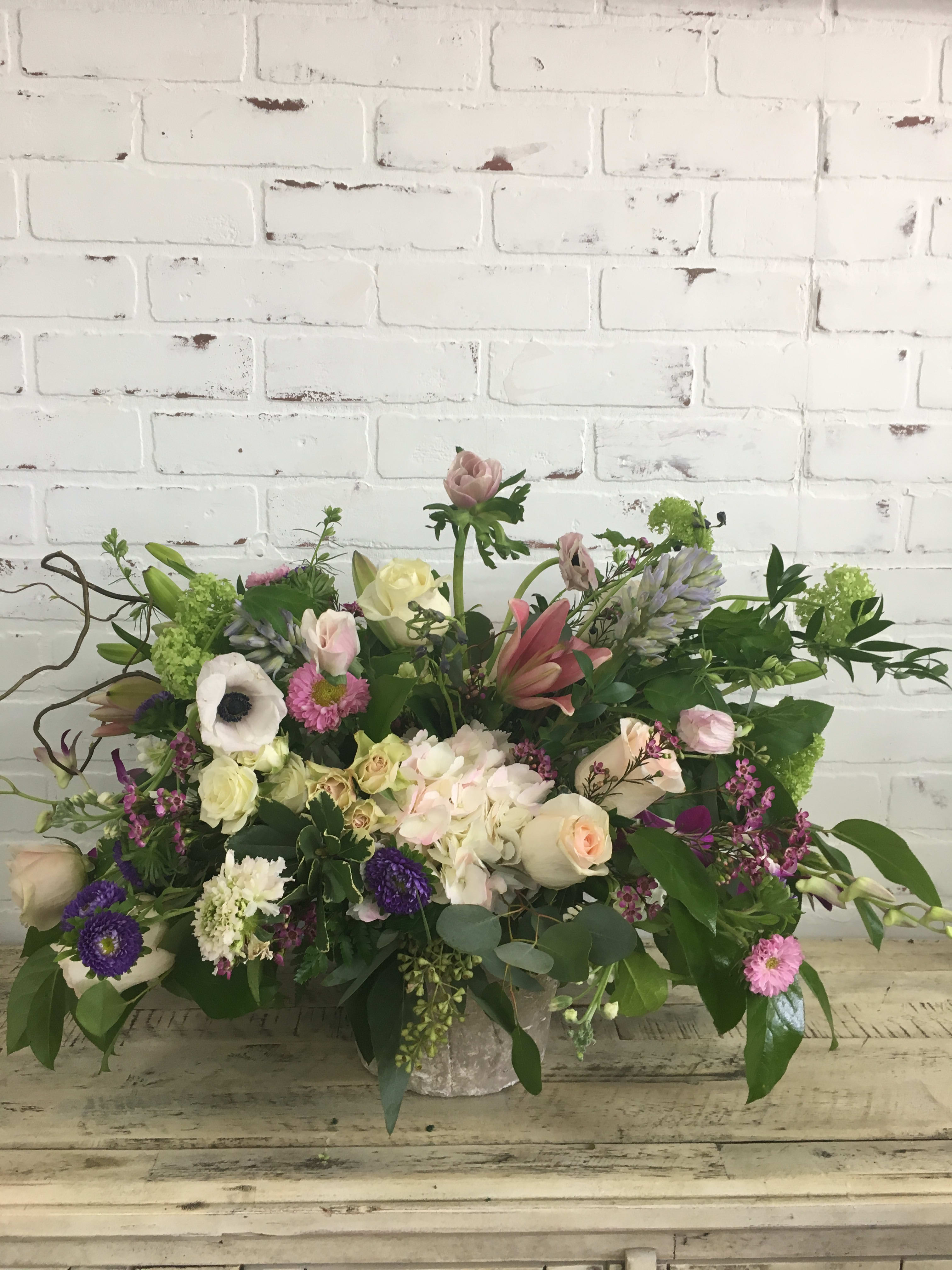 Agape - Gorgeous blooms beautifully displayed in an antique container