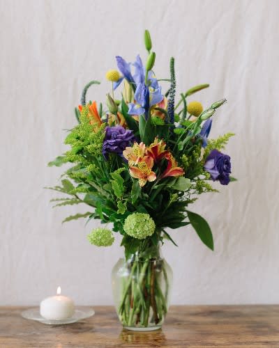Bright Blooms Bright Blooms - A classic spring mixture of asiatic lilies, iris, alstroemeria, and lisianthus, presented in a clear glass vase.