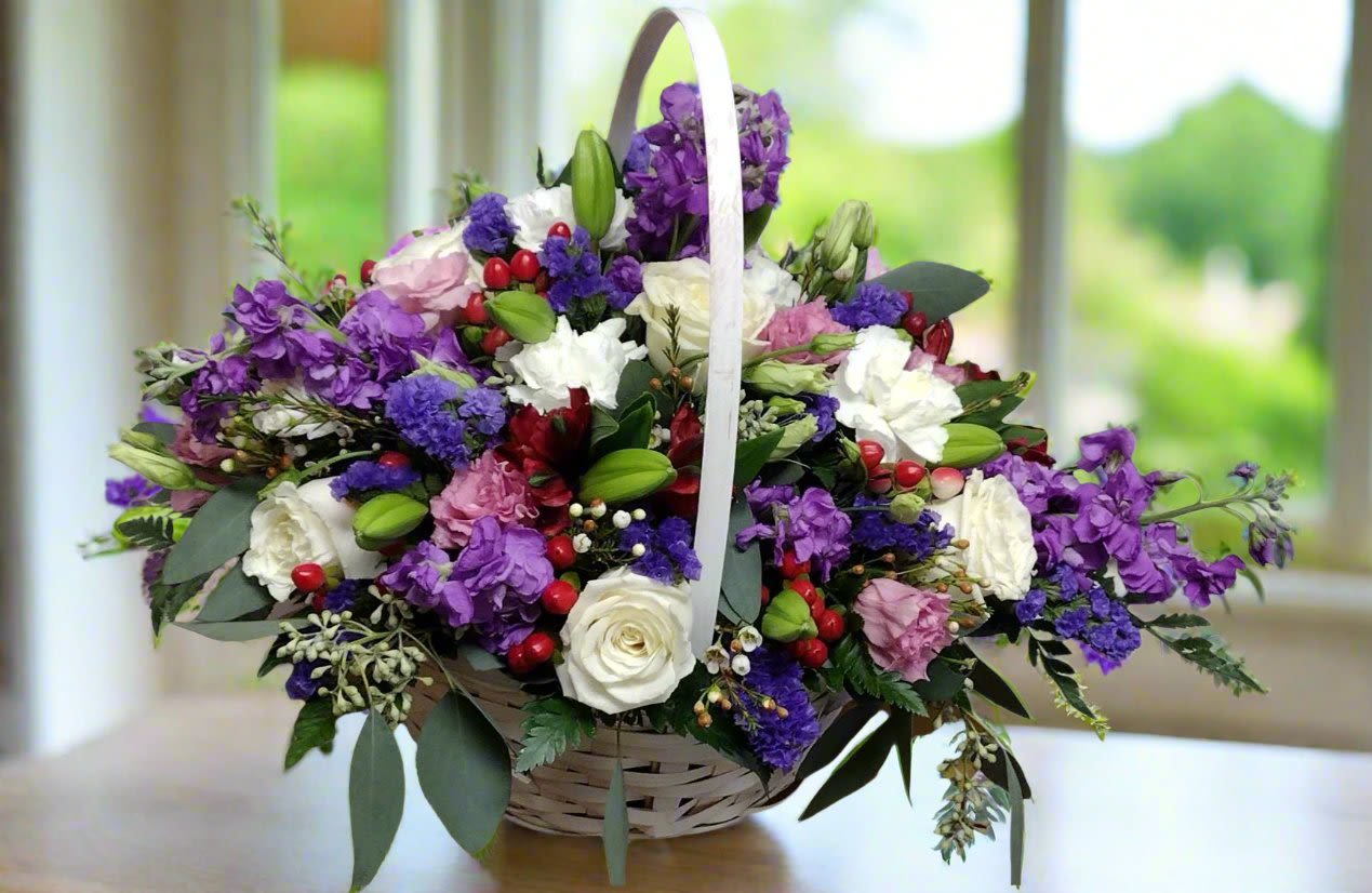 Purple Posies Basket - Elevate your gifting experience with our exquisite purple posies basket arrangement, bursting with vibrant purple posies that captivate the senses. This stunning collection features lush roses, fragrant stock, elegant lilies, and a variety of complementary blooms, making it the perfect choice for any occasion. Whether celebrating a special moment or simply brightening someone's day, this floral delight is sure to leave a lasting impression.  **When you request custom designs, we will create them to closely resemble the picture. Keep in mind that each design is unique and made just for you. Due to the nature of flowers, color substitutions may be required. Prices and availability of seasonal flowers can also differ.