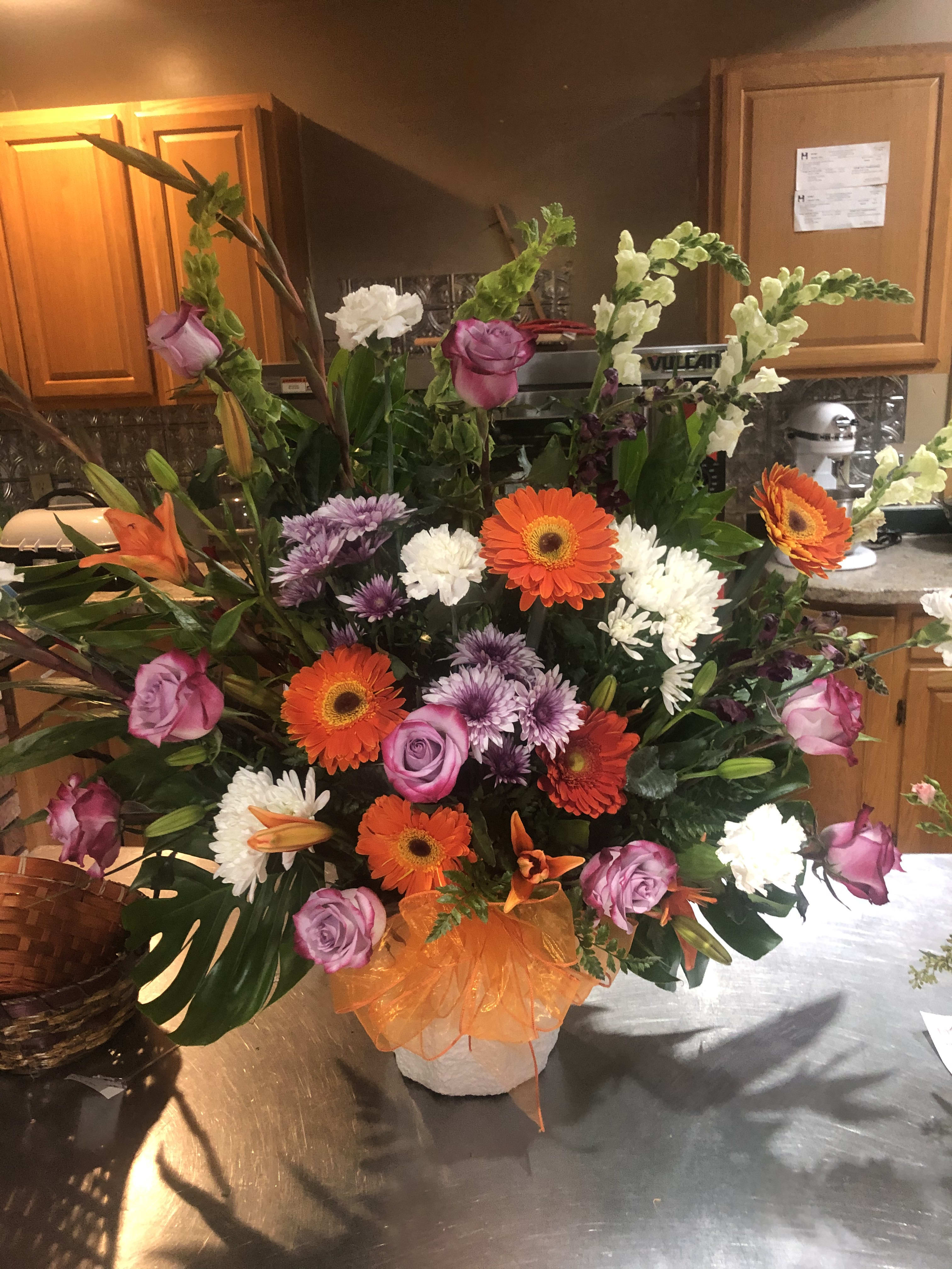 A sympathy arrangement for your loved one. A sympathy arrangement for your loved one. - A mix of gerbers, daises, gladiolus, snap dragons, roses, and carnations. Flowers and colors can be changed.