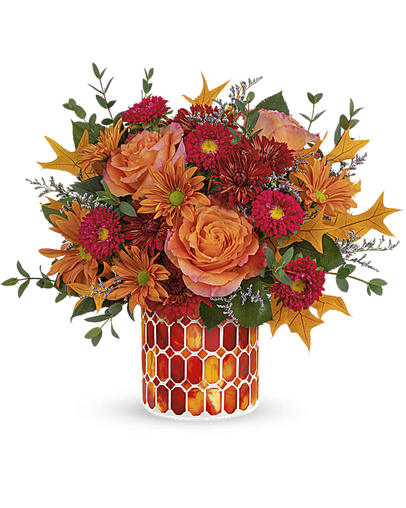 Autumn Aglow Bouquet - Artfully arranged in a beautiful keepsake vase of stained glass mosaic, this magnificent rose bouquet celebrates the special magic of fall. This beautiful bouquet includes orange roses, red matsumoto asters, bronze cushion spray chrysanthemums, bronze daisy spray chrysanthemums, purple limonium and parvifolia eucalyptus, accented with preserved oak leaves. Delivered in Teleflora's Autumn Radiance Mosaic vase.
