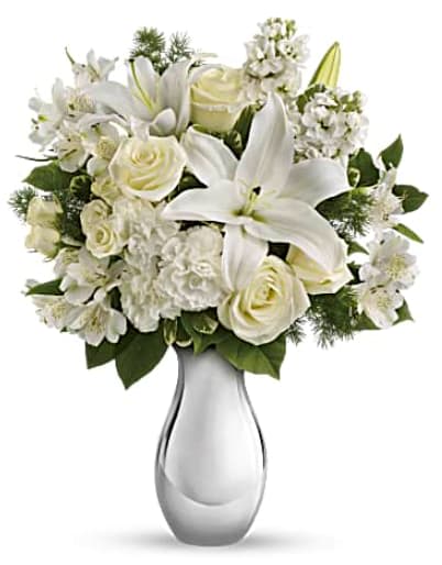 Teleflora's Shimmering White Bouquet - So simple, and so breathtakingly beautiful. This holiday flower arrangement features an all-white bouquet of roses, lilies and more in an exquisite silver reflections vase that will be cherished for years. Perfect for Christmas, Hanukkah - or just because. The gorgeous bouquet includes white roses, white spray roses, white oriental lilies, white alstroemeria and white stock accented with assorted greenery. Orientation: All-Around