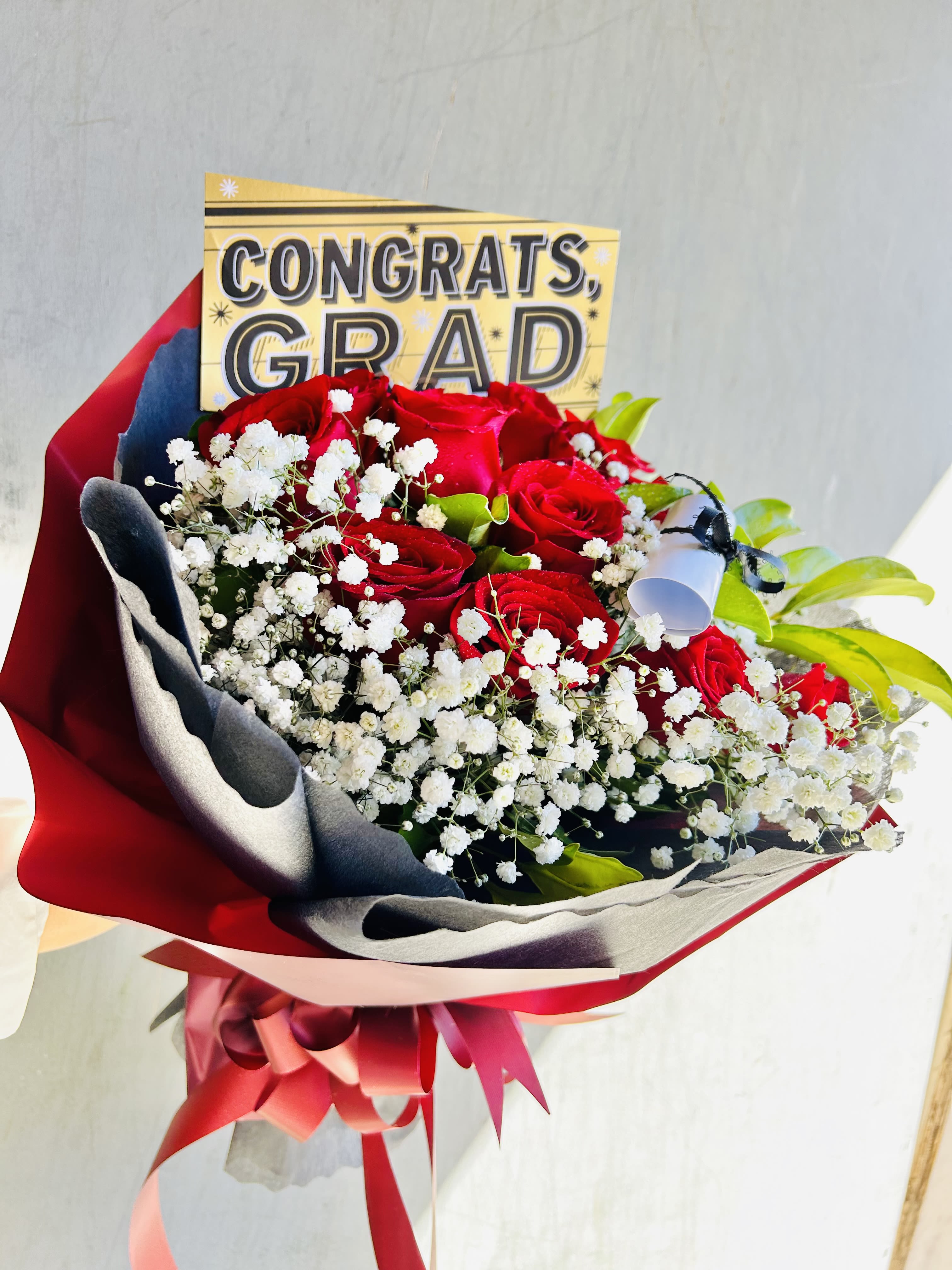 Hello Grad! - Beautiful graduation bouquet featuring red roses, baby breathe, and green accents.