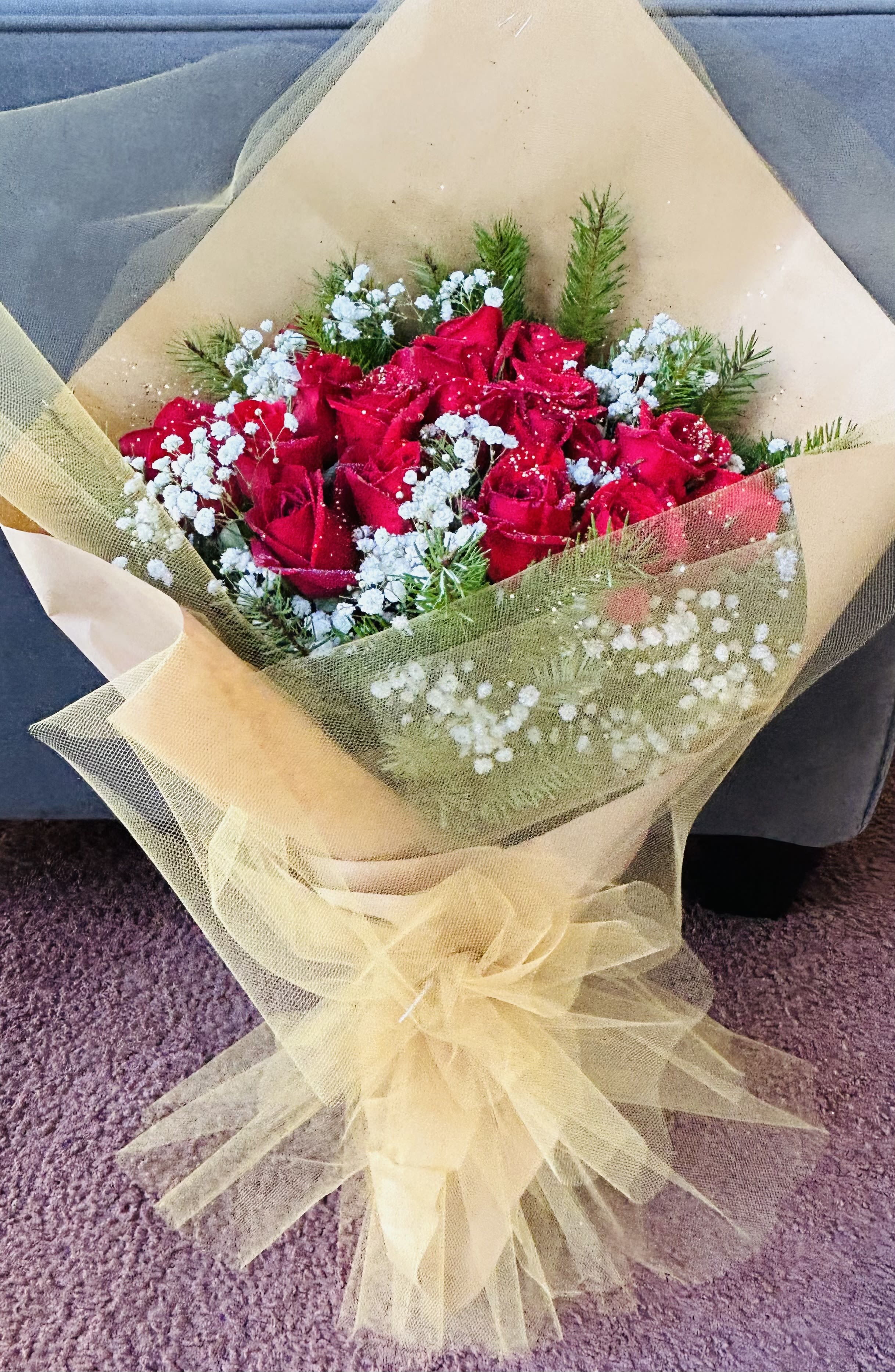 Red Velvet  - Beautiful bouquet featuring red roses, baby breath, green accents, and gold wrapping. 