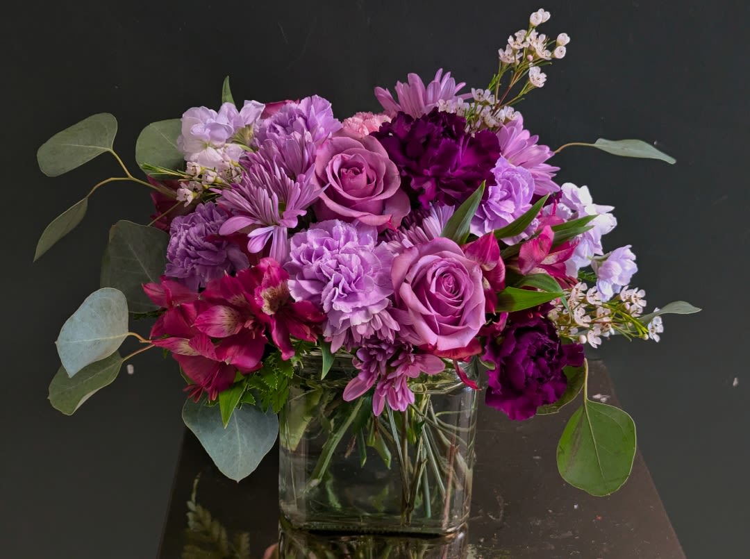 Pretty in Purple by Hannah's Pretty in Purple by Hannah's - Fill yourself in the beautiful richness of purple. Pretty in Purple offers a nice mix of shorter and long lived florals to offer the recipient a lasting experience filled with exciting, rich color emersion!