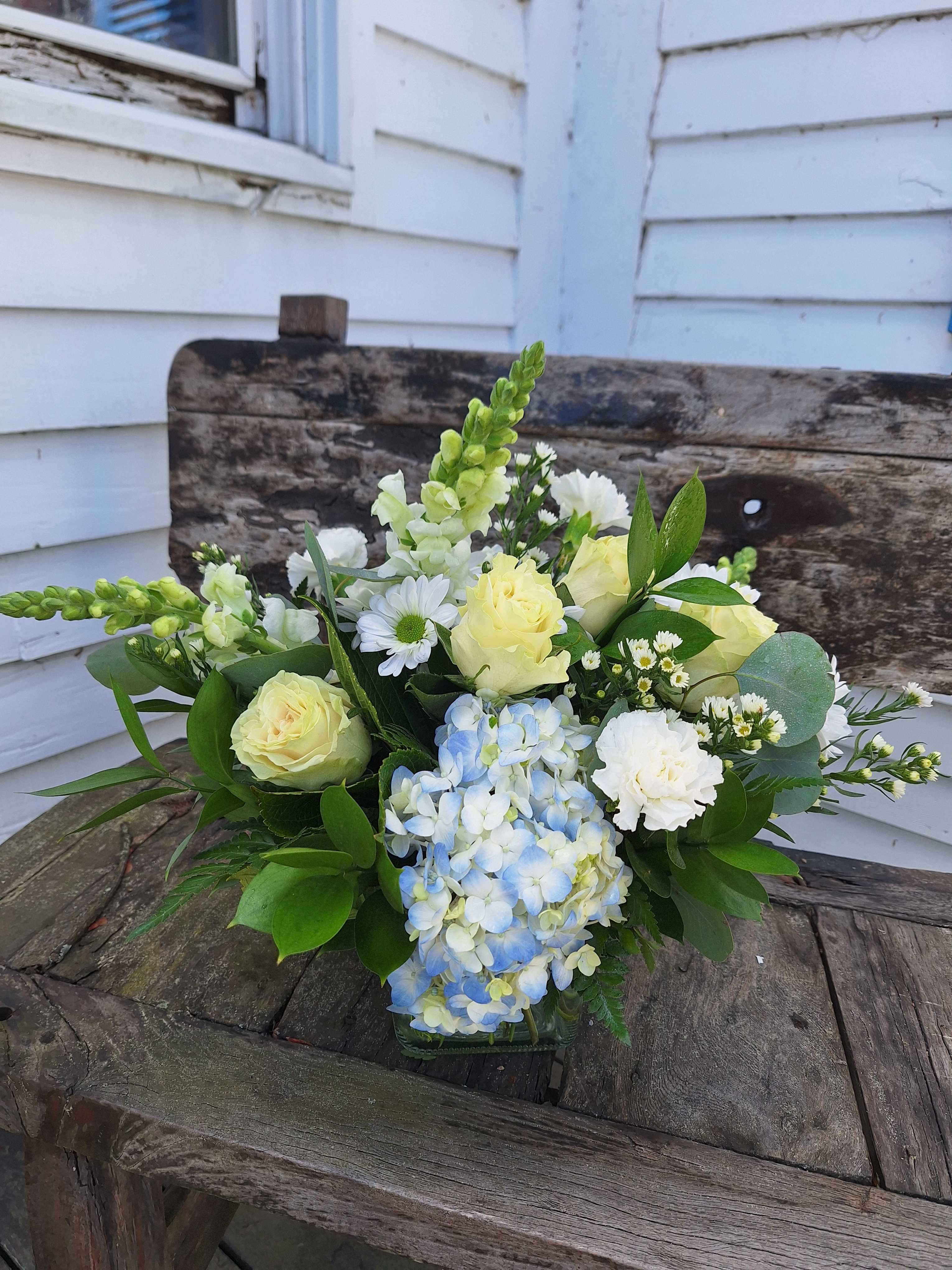 Whites and Blues Whites and Blues - Blue hydrangea, white snap dragon, white roses and daisys with white carnations and monte