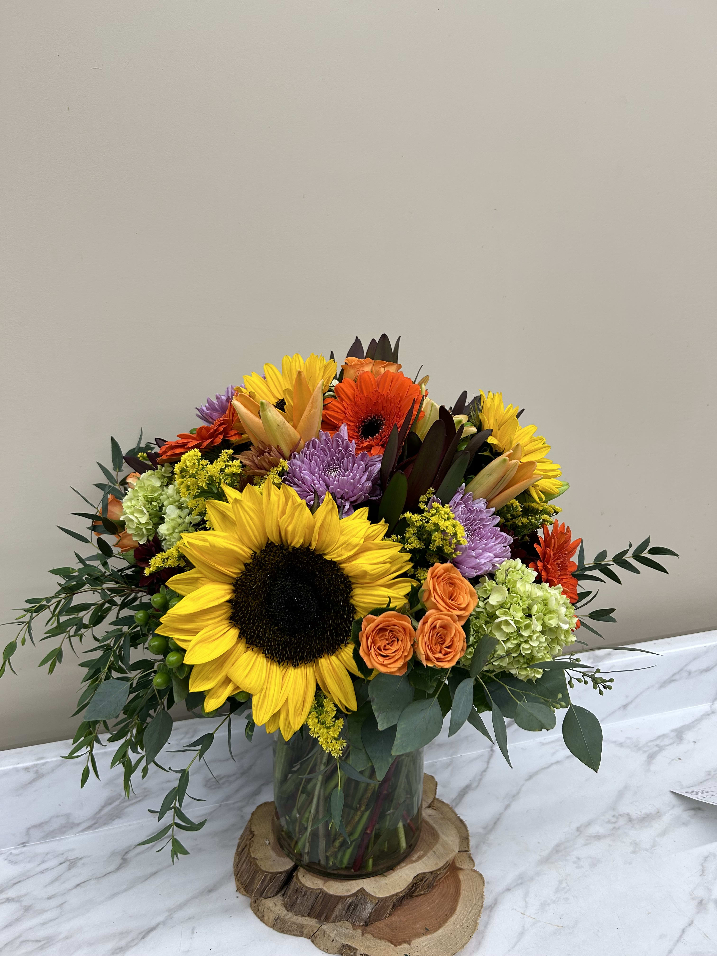 Mixed all shades flowers in vases , sunflowers , orange Mixed all shades flowers in vases , sunflowers , orange