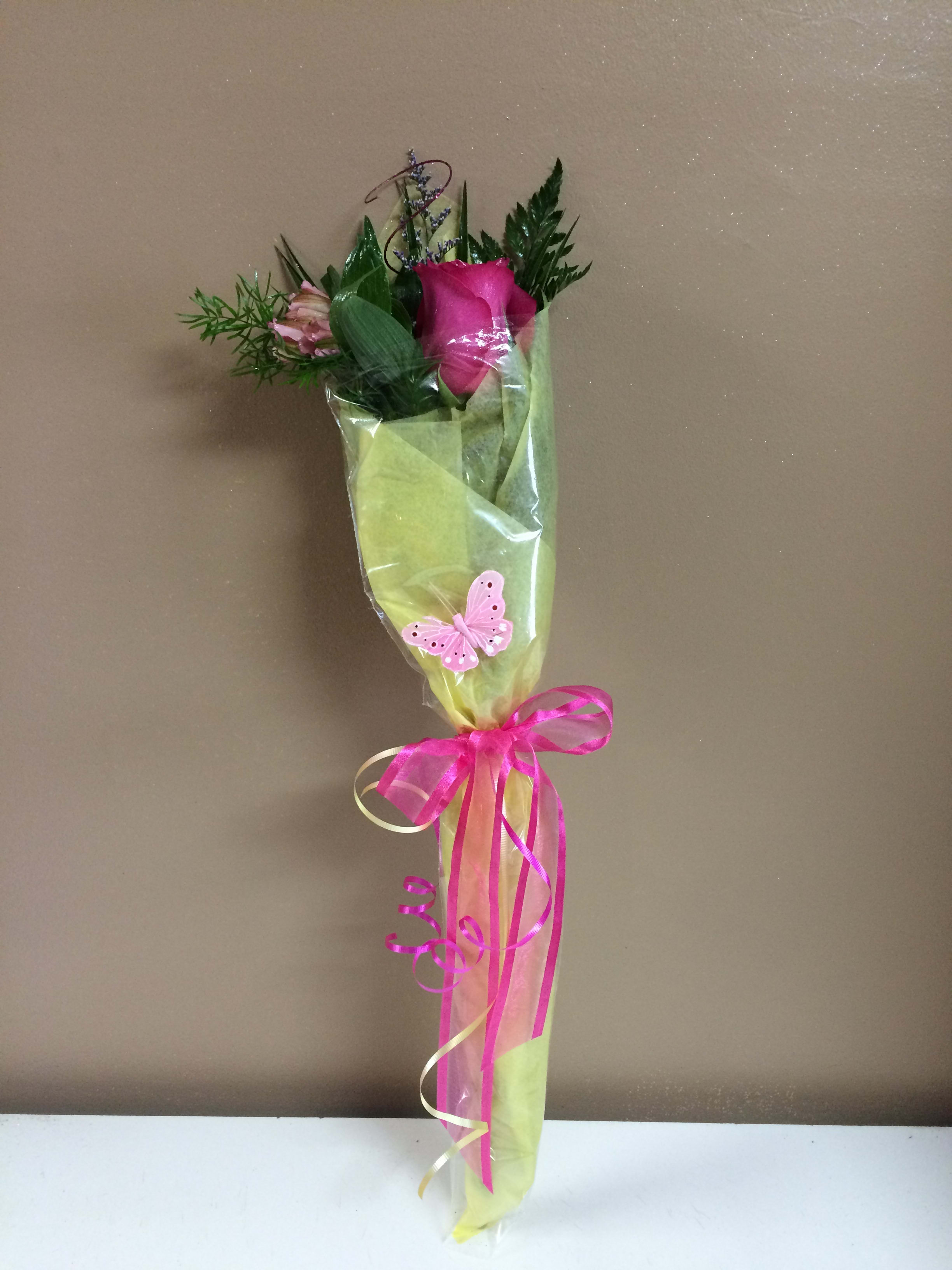 A SINGLE - A single rose wrapped in tissue