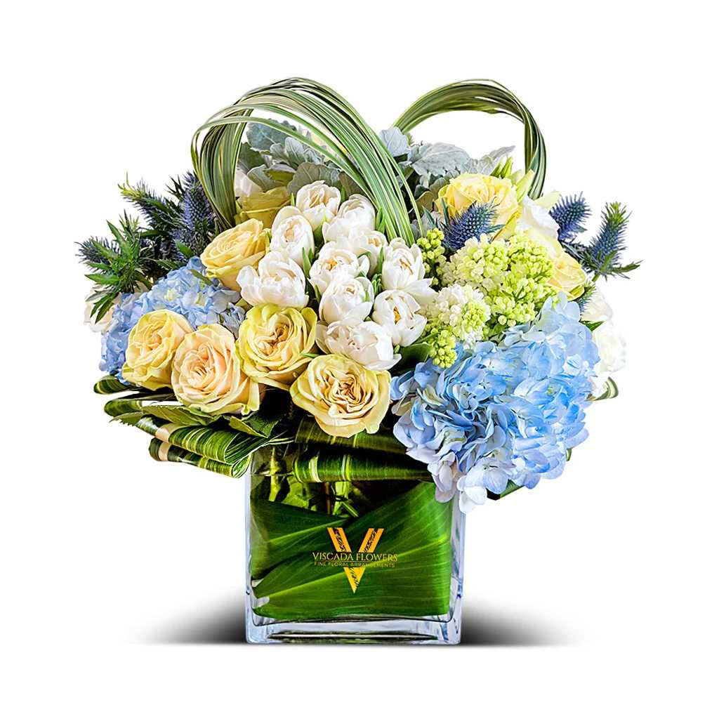 Ocean Spring - This captivating bouquet combines blue hydrangeas, white tulips, blue sea holly, and other blooms in serene hues. Perfect for adding a touch of coastal beauty and freshness.