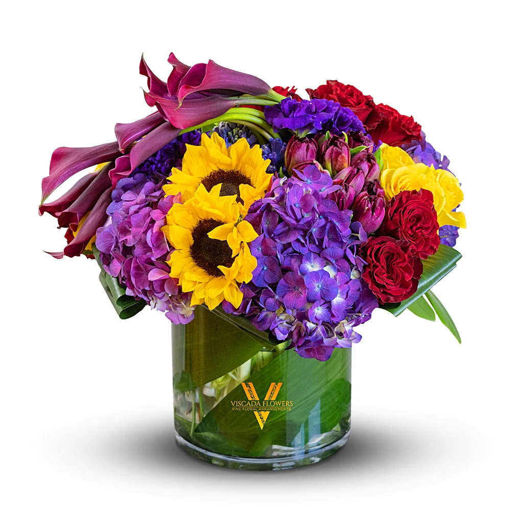 Scandinavian Sun - This radiant bouquet features yellow sunflowers, purple hydrangeas, red roses, and cascading calla lilies. Perfect for adding a burst of vibrant charm and capturing the essence of a sunlit Scandinavian landscape.
