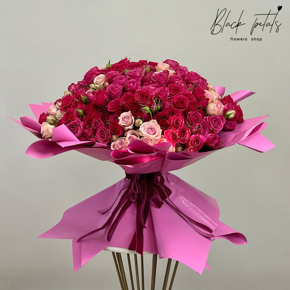 Fuchsia Queen Hand-Tied Bouquet Fuchsia Queen Hand-Tied Bouquet - Cherish your gifting experience with our Fuchsia Queen Hand-Tied Bouquet. Each bloom is meticulously arranged to create a stunning dome shape. This exquisite ensemble features a captivating blend of red, hot pink, and light pink baby roses. Perfect for making your special someone feel like royalty, it's a regal gesture for birthdays, anniversaries, or any occasion. Hand-tied with care and attention to detail, this bouquet exudes elegance and charm, sure to leave a lasting impression. Arrangement includes: Fresh BP Signature Baby Roses BP Wrapping Paper and Ribbon Care instructions Custom greeting card DISCLAIMER: FRESH FLOWERS: These are fresh-cut flowers and are perishable. Please follow the care instructions in Care & Handling.
