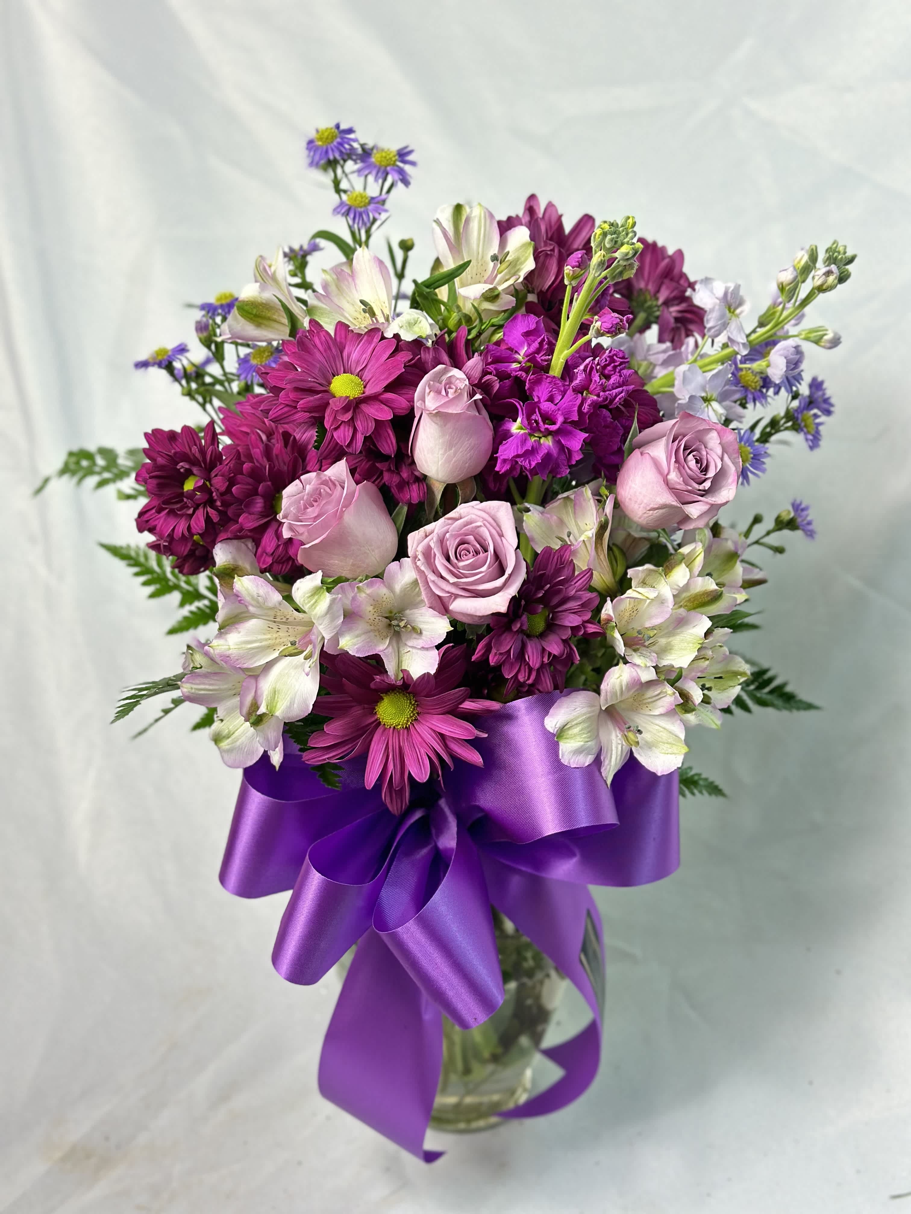 Purple Passion - This bouquet is for those passionate about purple. An array  of purple shades of Roses, Stock, Alstroemeria, Daisies &amp; filler mix beautiful hues together. Send a purple bouquet gift of love. 