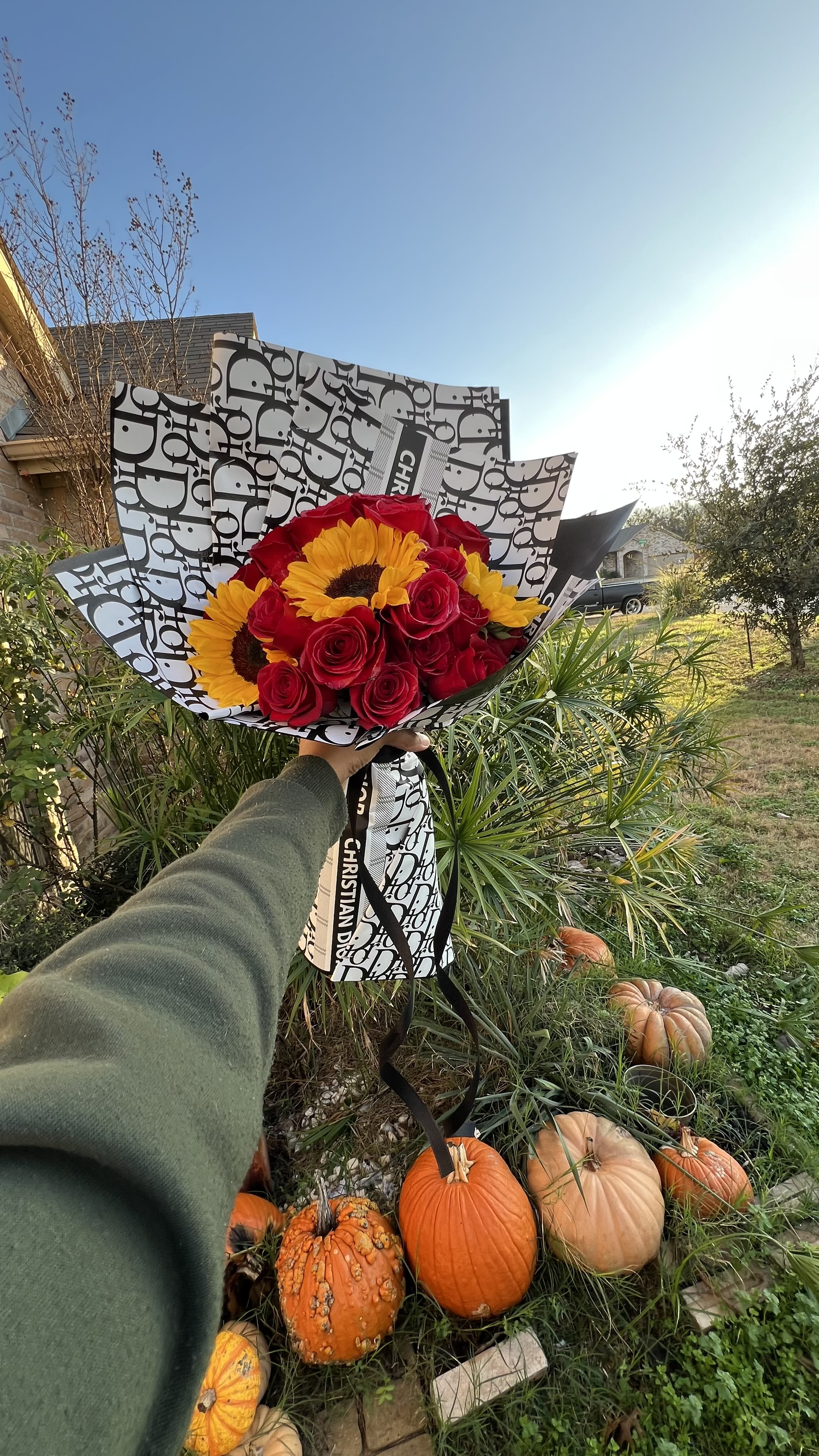 Red Rose & Sun Flower Dior Bouquet  Red Rose & Sun Flower Dior Bouquet  - 24 Red Roses  5-6 Sunflowers   Add a touch of designer flair to your gift with our Sunflower and Rose Designer Bouquet. Each bouquet features vibrant sunflowers and red roses, carefully wrapped in designer paper - chosen by our expert florists. (Fancy Christian Dior, Prada, Gucci, or Louis Vuitton paper, anyone?) Brighten someone's day with this playful twist on a classic bouquet.