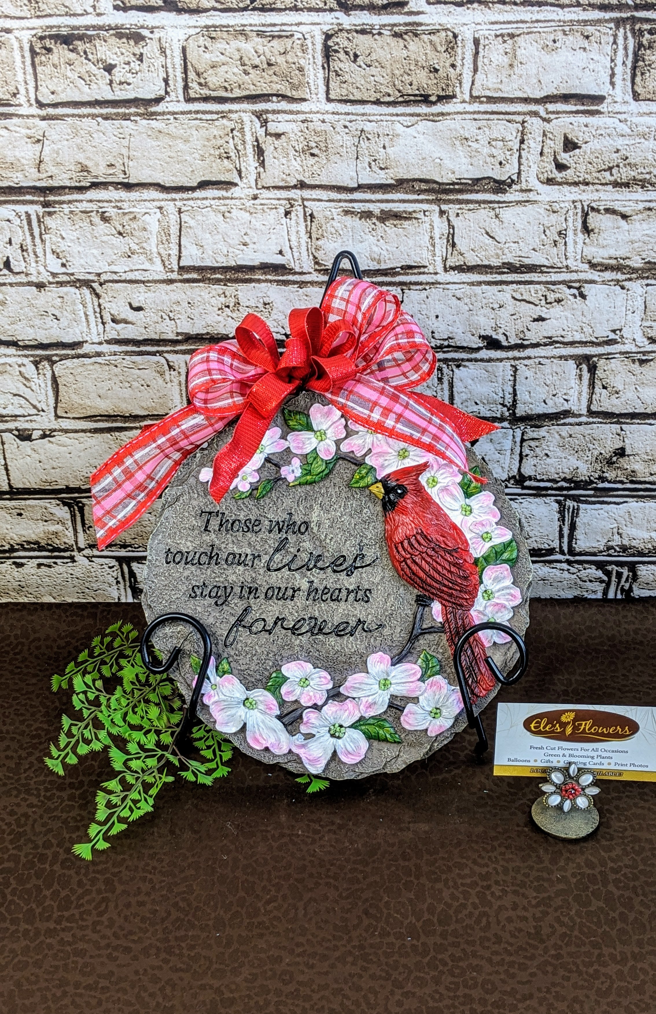 Sympathy Stone - Lives Forever Sympathy Stone - Lives Forever - A sympathy stone is a heartfelt memorial gift, crafted from durable resin. Engraved with comforting words, symbols, and images, it serves as a lasting tribute to a loved one, providing solace during times of grief. Perfect for gardens, memorial areas, or indoor displays, this stone is a meaningful reminder of love, loss, and cherished memories. This stone has the phrase, "Those who touch our lives stay in our hearts forever." Stand included. Approximate Dimensions: 9"H x 9"W