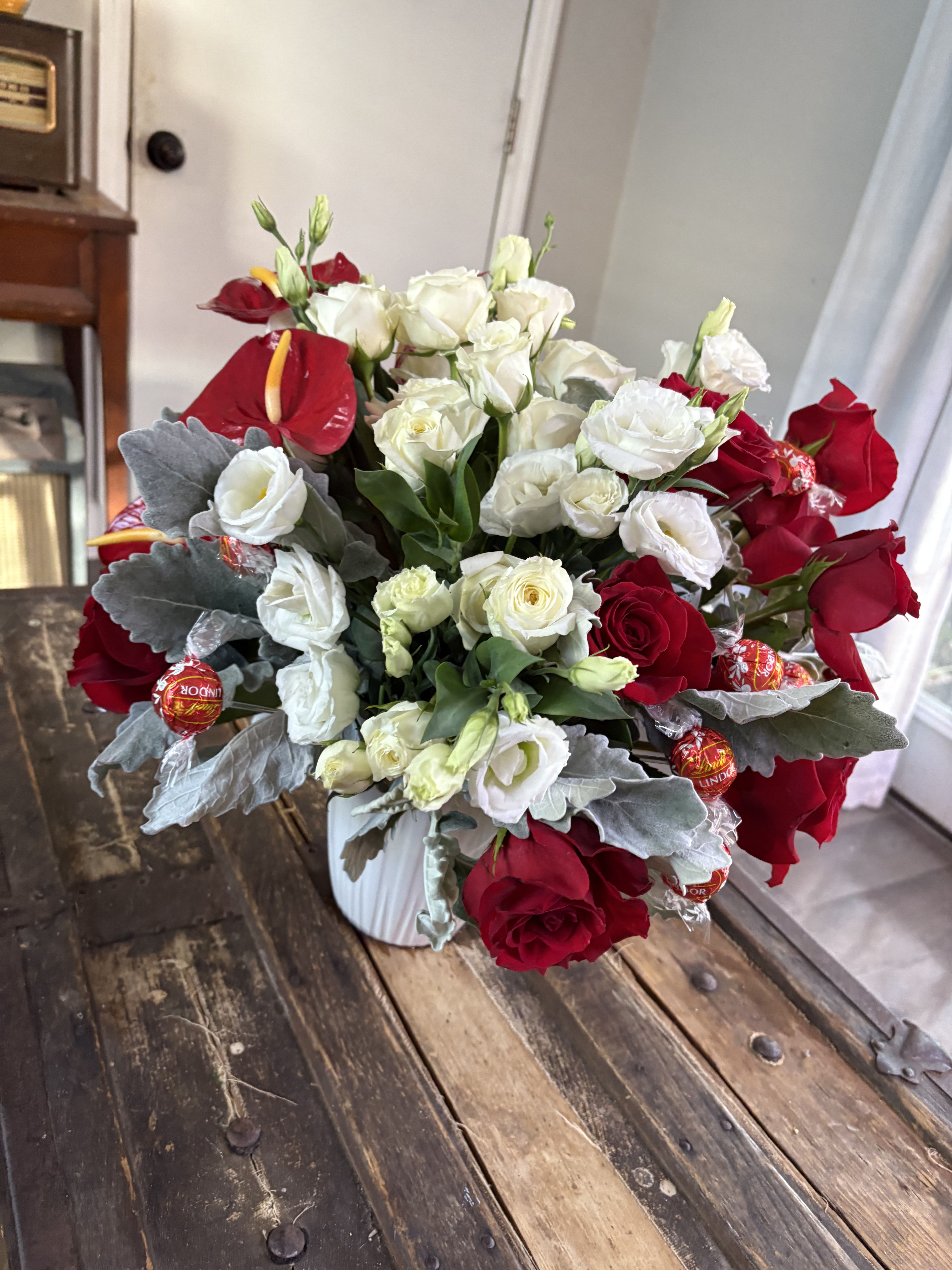 Red and white  - Beautiful mix of red and white flowers with chocolates 