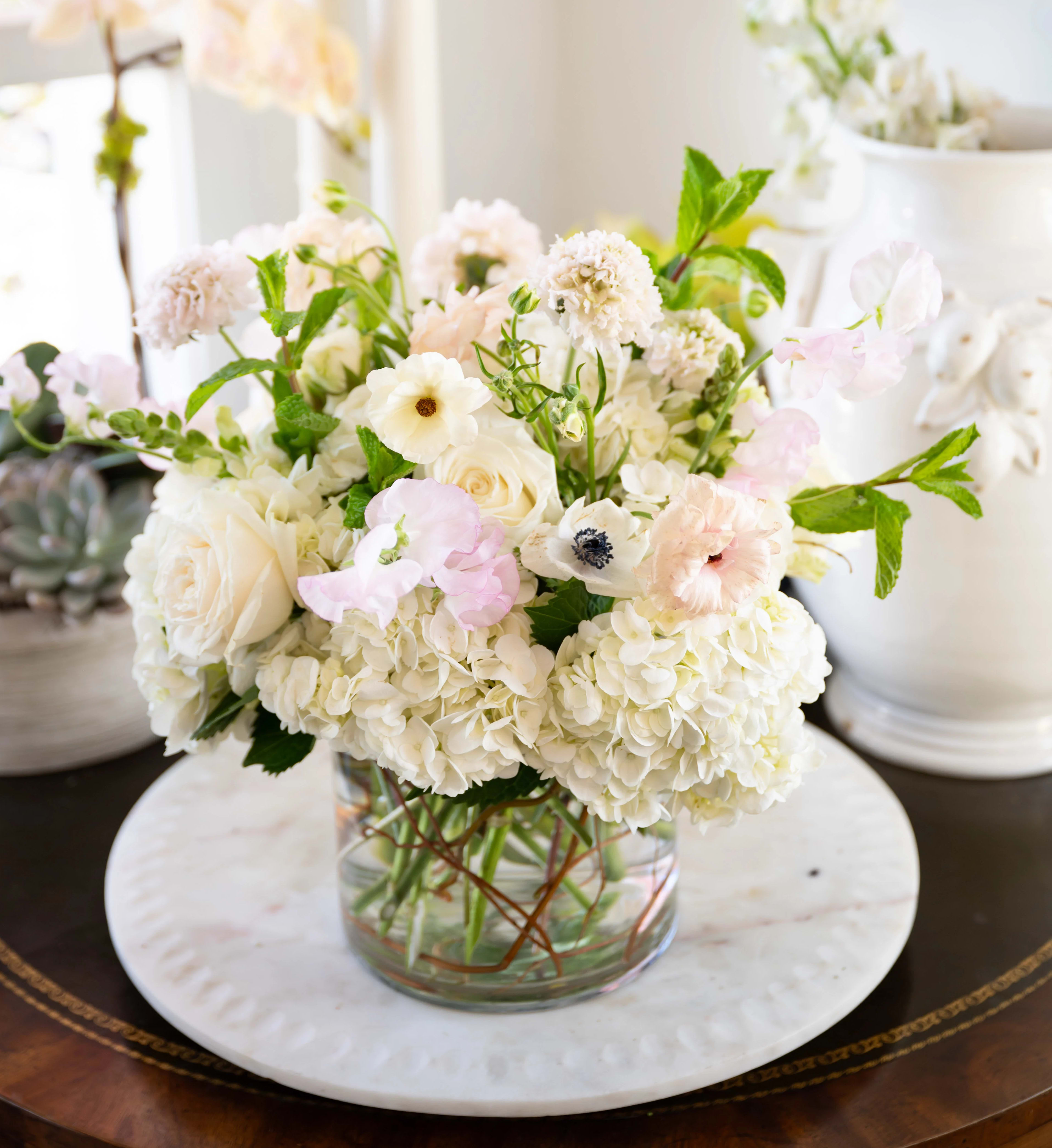 The Juliana  - Exquisite blush-tone seasonal flowers in a clear vase. 