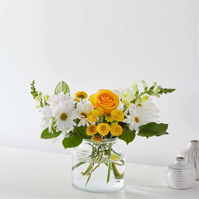 Sun Salutation Bouquet - Greet the morning with fresh yellow snapdragons, white daisies, and peach lilies to help you start the day on a sunny note. Details The Premium Bouquet is approximately 19&quot;H x 19&quot;W.