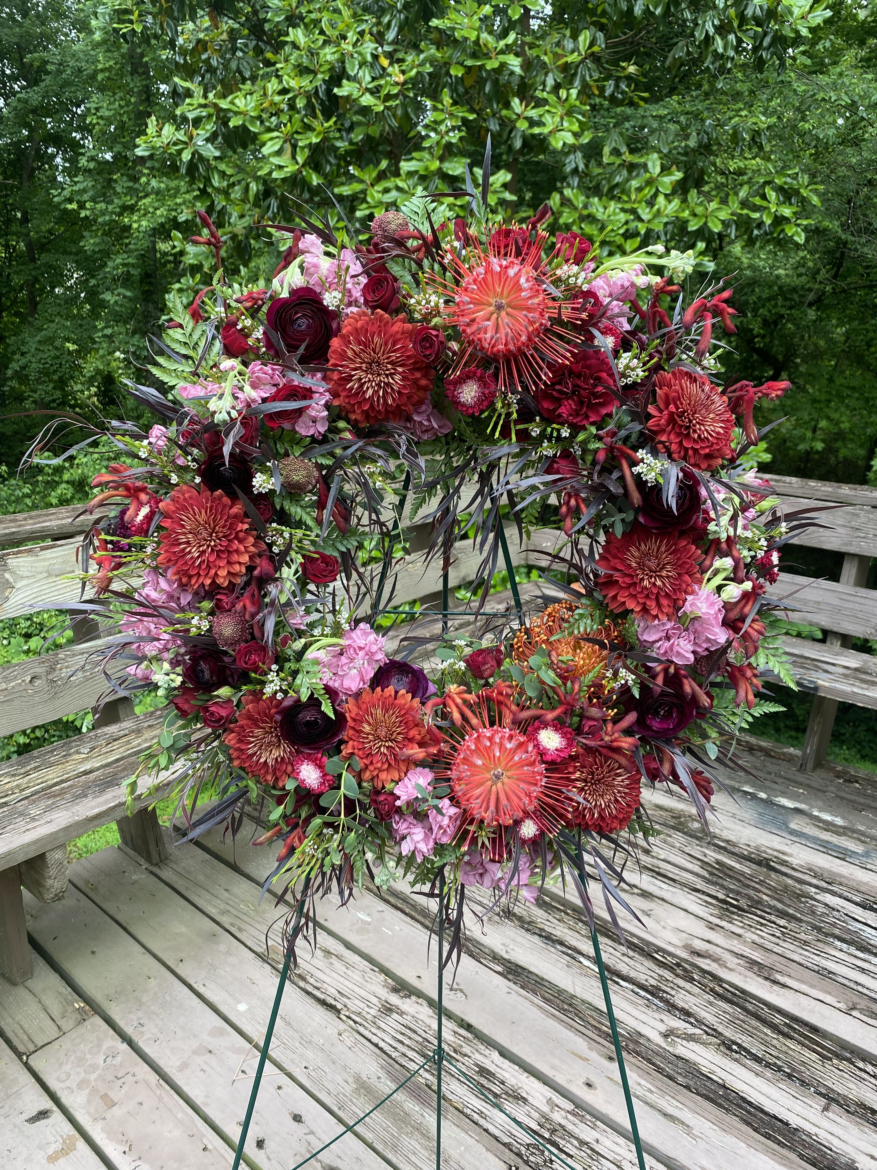 Beautiful and Lovely  - Dramatic funeral spray or wreath with a variety of flowers. Flexible color options. Usually around 5’-6’ in height. Some flowers are seasonal and depend on availability. 