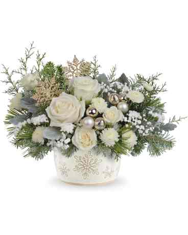 Starry Snowflakes Bouquet Starry Snowflakes Bouquet - Create unforgettable holiday memories with this special delivery of classic Christmas roses, elegantly presented in a hand-painted, distressed serving dish centerpiece adorned with a charming snowflake design. Perfectly food-safe, it adds a festive touch to your seasonal celebrations. Starry Snowflake Centerpiece showcases white roses, spray roses, and button spray chrysanthemums, accented with sinuata statice and gypsophila. Designed with dusty miller, noble fir, white pine, and cedar, presented in Teleflora's Snowflake Symphony Dish, it creates a timeless holiday centerpiece.