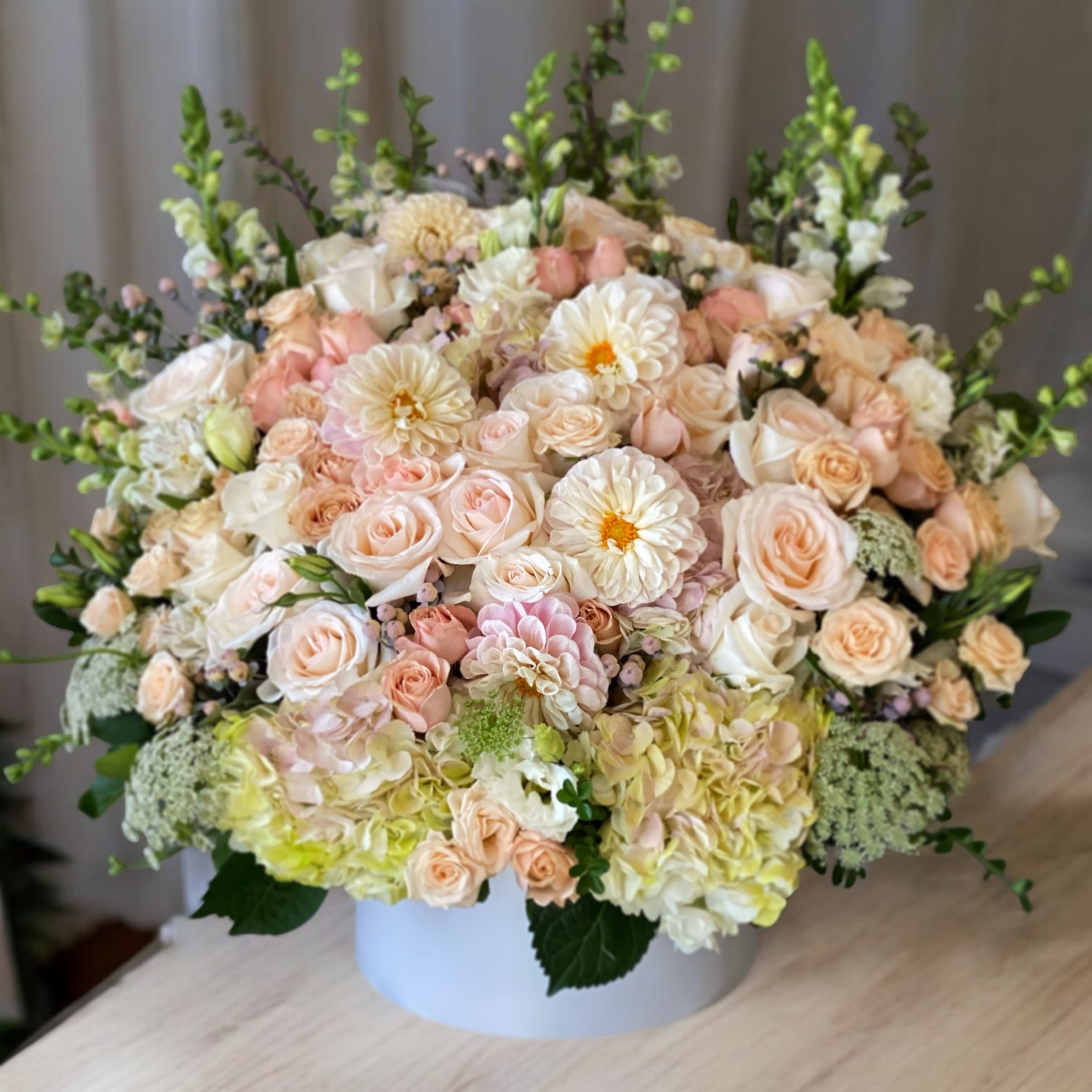 Victoria Victoria - This creation is all about soft and silky. Light peach color roses and dahlias are in harmony, carefully designed to fit any taste and choice.
