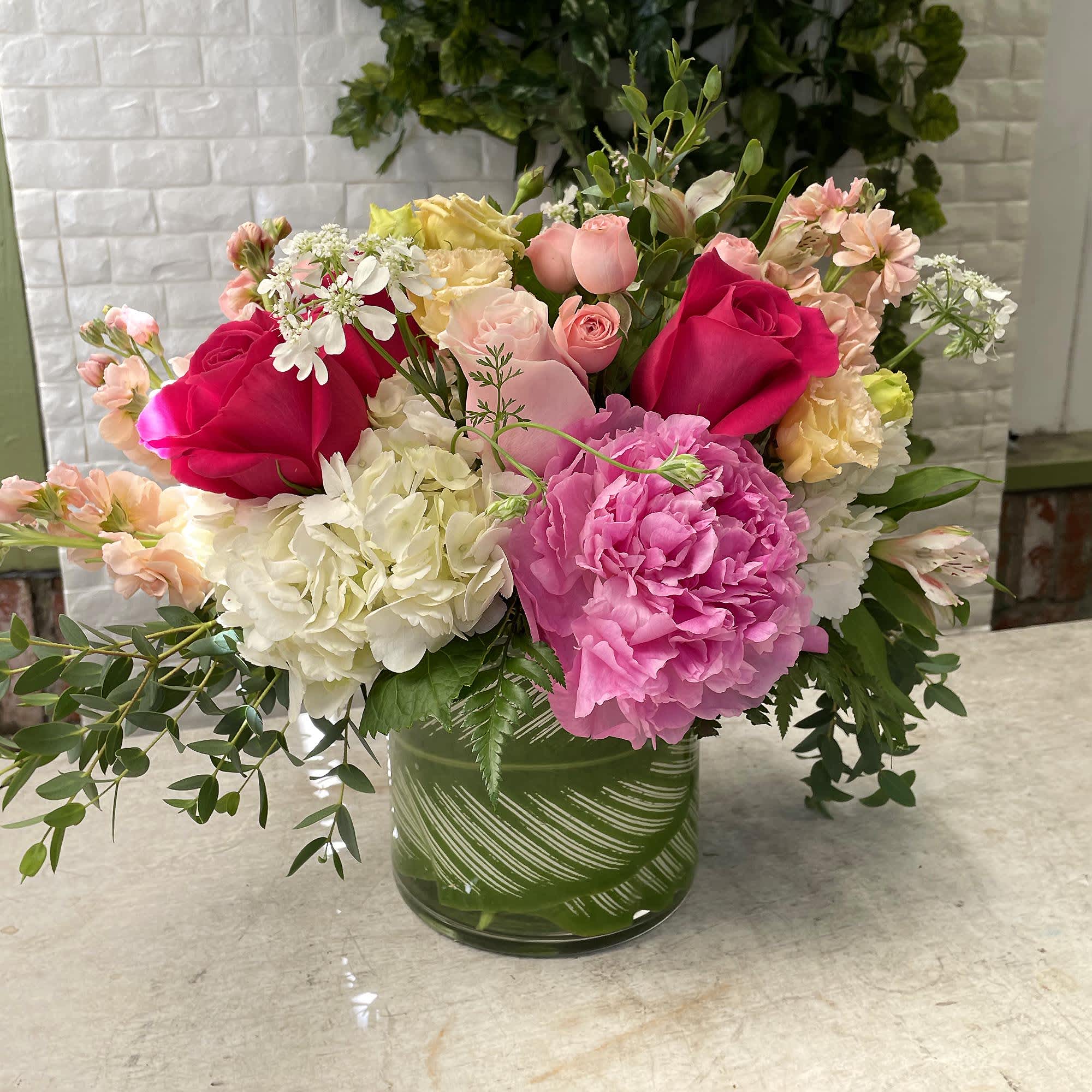 Gazebo - Stay out of the sun with a Gazebo from Palisades Flowers. Our Gazebo comes with one pink peony, spray roses, lisianthus, hot pink roses, peach stock, and hydrangea. The Gazebo comes with a 5x5 vase and is approximately 9” tall x 10” wide