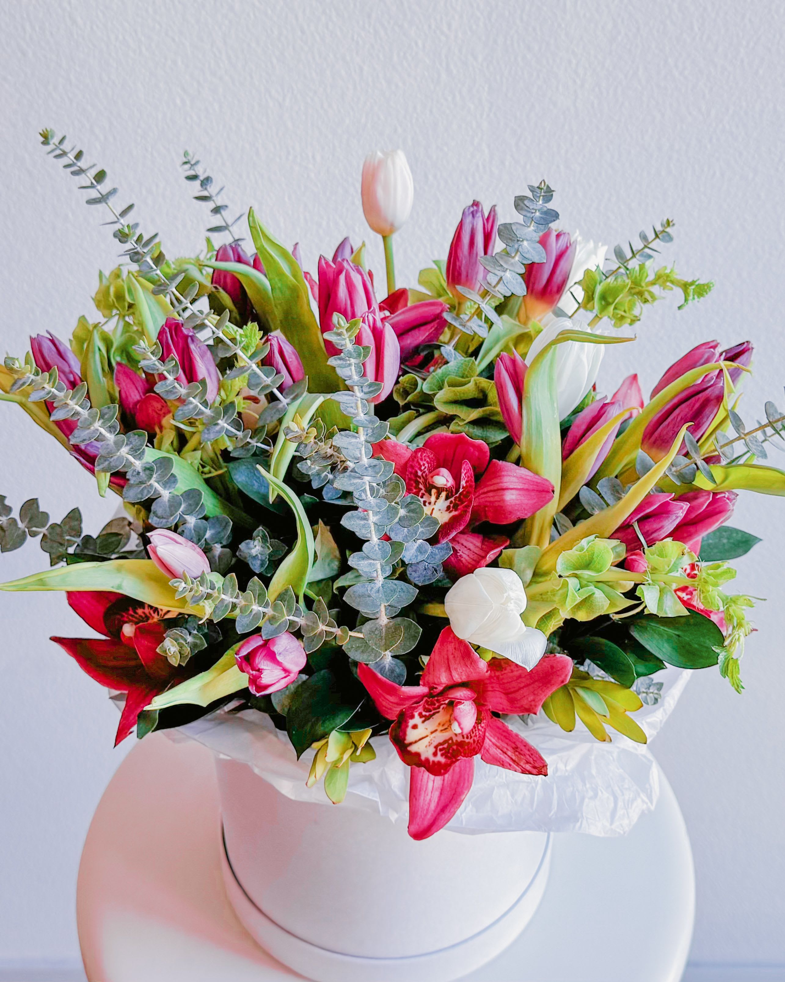 Blooming Marvelous - This bouquet is a joyful celebration of life, bursting with vibrancy and elegance. The deep crimson blooms, paired with soft white accents and delicate greenery, create an air of romance and freshness. It feels like a quiet morning in spring when the world awakens with new possibilities. This arrangement effortlessly balances lush richness with natural grace, leaving you with a sense of calm and beauty.