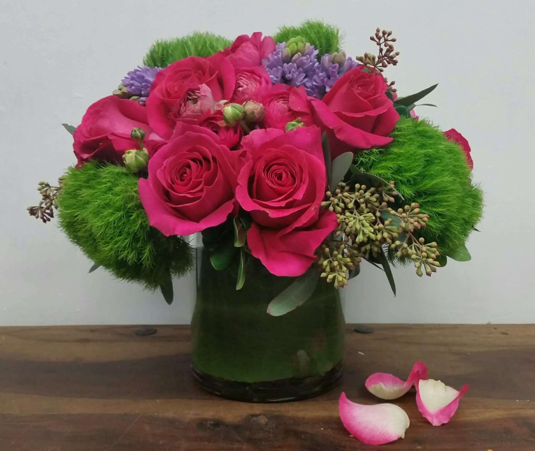 Pink Floyd Pink Floyd - Our fun and bright arrangement featuring hot pink roses, fresh greenery and complementing florals in a leaf wrapped cylinder.