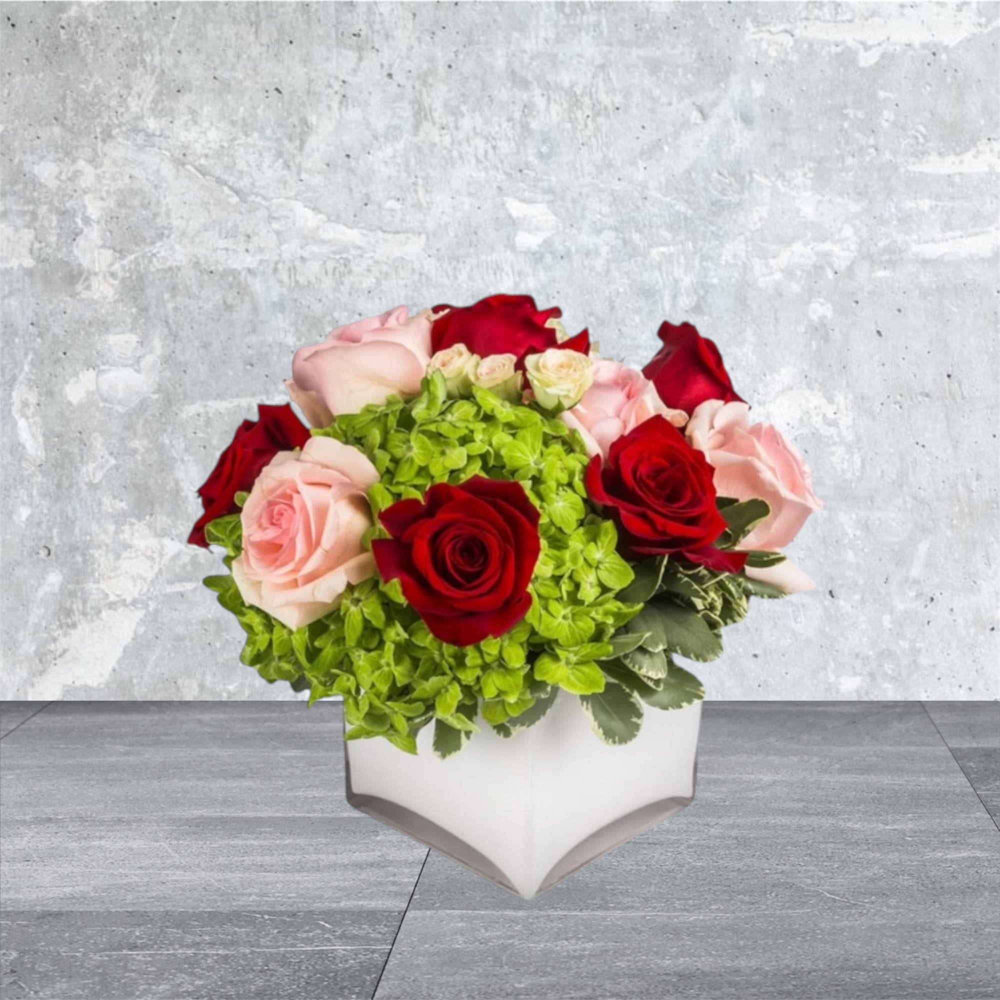 Young Love - This arrangement includes blush pink roses, red roses, blush spray roses, white hydrangea. Young Love is the perfect gift to wish someone a happy birthday or to say thank you.   APPROXIMATE DIMENSIONS:10&quot; H X 11&quot; W X 11&quot;L