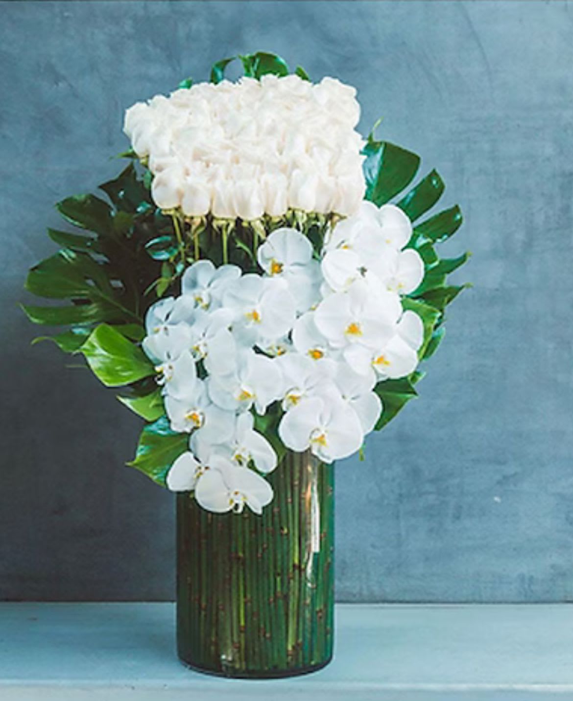 White Orchids and roses - White orchids and an amazing bunch of imported white roses arrange in a glass container