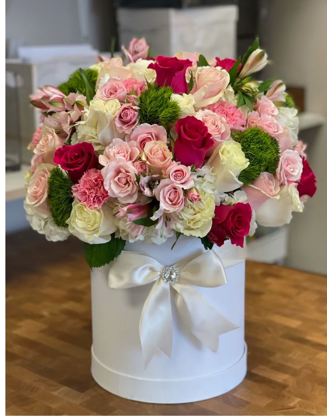 Box of dreams  - Sunning white hat ox with pink, red roses and hydrangeas and a touch of green dyantus also available in 3 or more sizes 