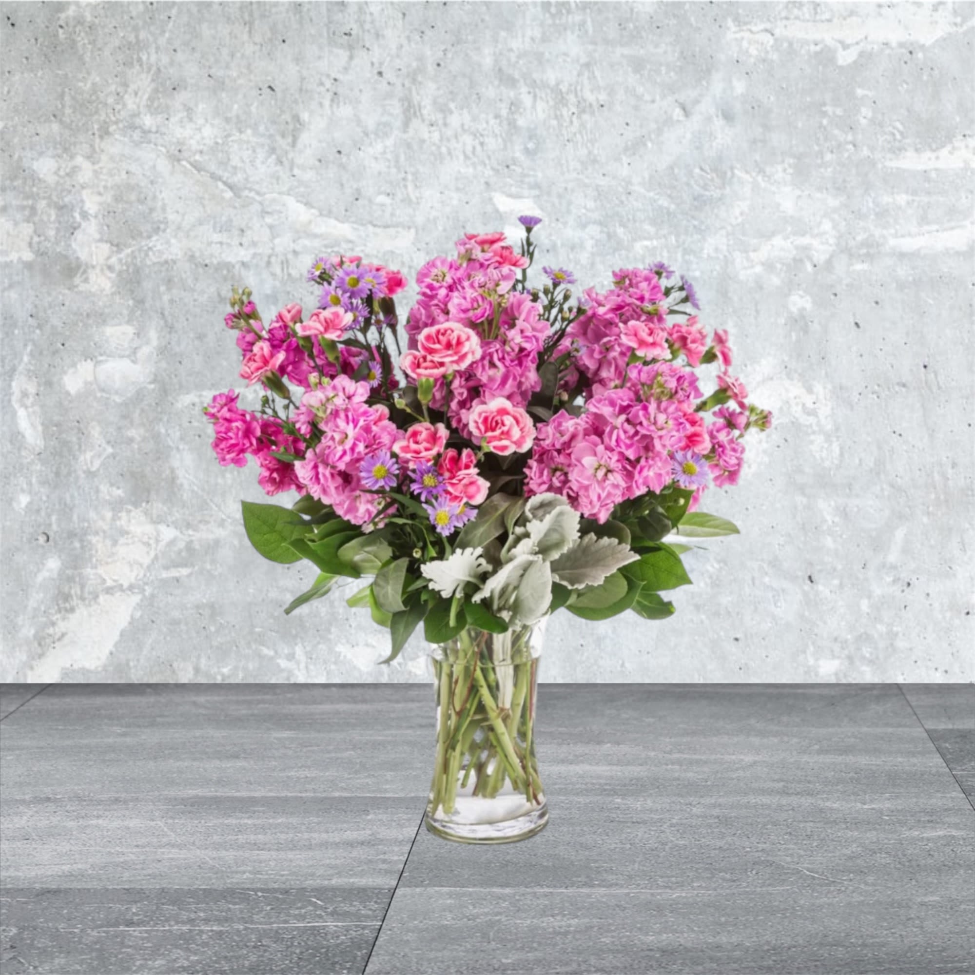 Uptown Girl - This arrangement is a pink and purple confection featuring sweet-smelling stock flowers and purple asters. A great gift for birthdays, women's day, or breast cancer awareness month.  Approximate Dimensions: 12&quot;D x 17&quot;H