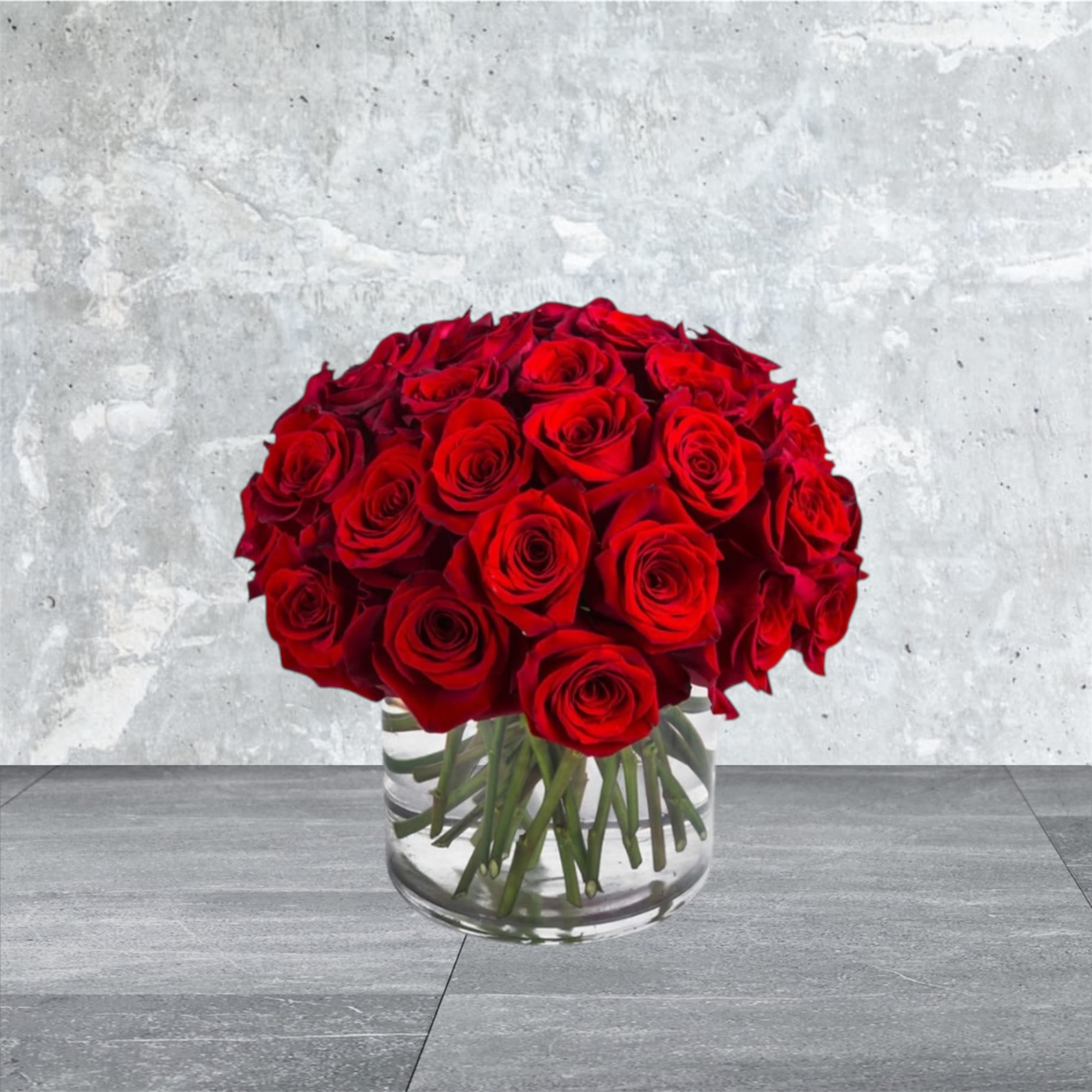 Three Dozen Red Roses - Make a bold statement with this beautifully simple design. Three Dozen Red Roses by BloomNation™ is the perfect gift for Valentine's Day, an Anniversary, or when anytime you're feeling romantic.   Arrangement Details: Three dozen red roses in a glass cylinder vase. 