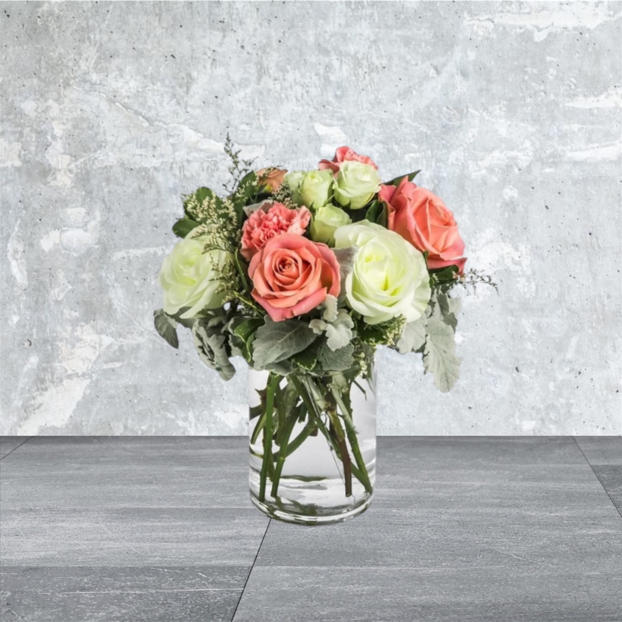 Sweet &amp; Subtle - This arrangement includes pink roses, white roses, white spray roses, pink carnations, and dusty miller. Sweet &amp; Subtle by BloomNation™ is the perfect gift for a birthday, thank you, or just because.   APPROXIMATE DIMENSIONS: 9&quot; H X 10&quot; W