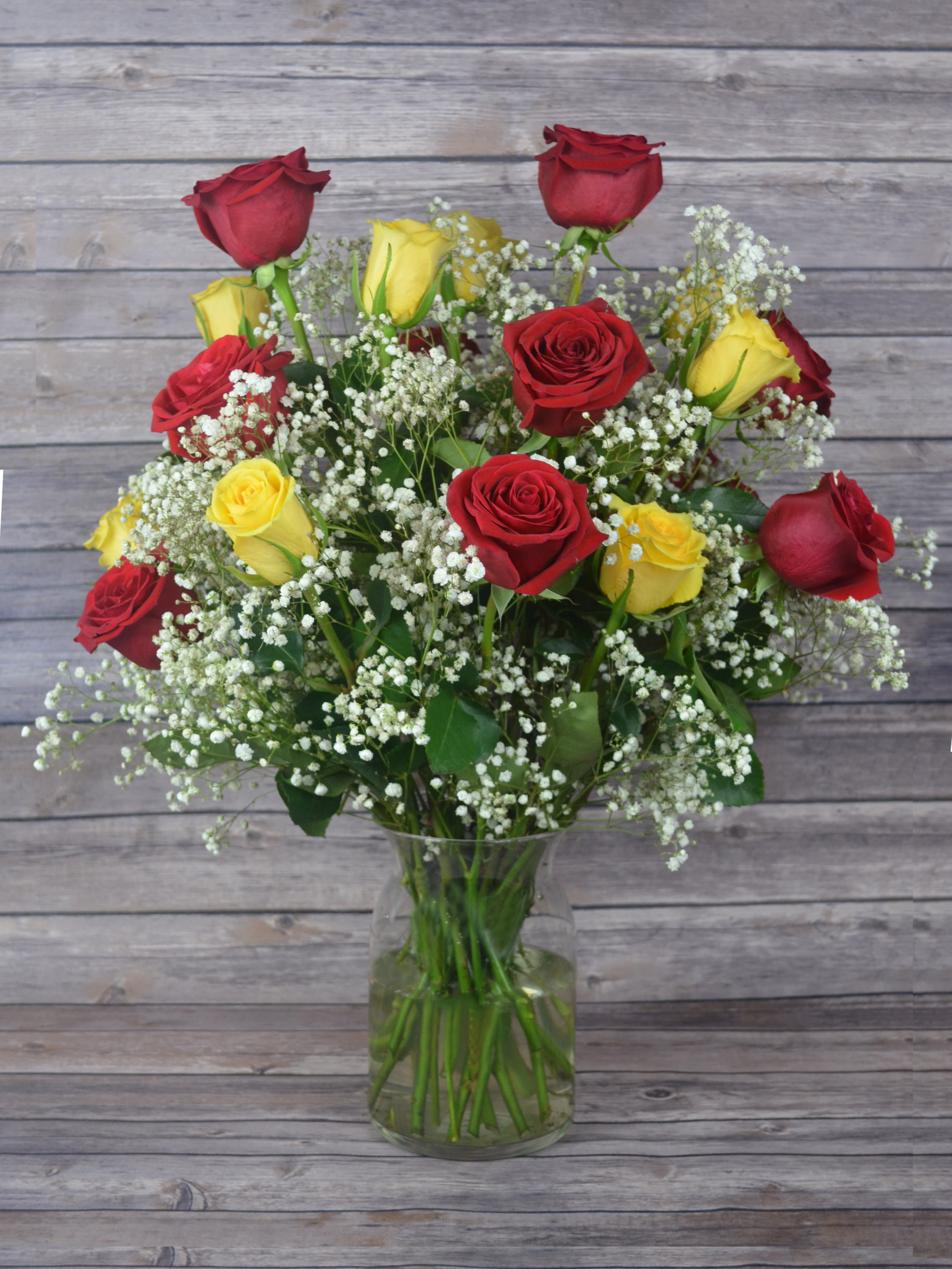 Lover and Friend - No deeper meaning. Show them why you’re perfect for each other. All bouquets are arranged by our professional floral design team accented with seasonal filler (i.e. greenery, baby’s breath, etc.) inside an elegant glass vase or gift box. Blooms are hand delivered in person to enhance any celebration or a “just because” surprise. Our team selects the freshest flowers available, so shade of rose may vary due to seasonal availability. When artistically designed in a clear glass vase arrangement measures approximately 23&quot;H x 18&quot;L.