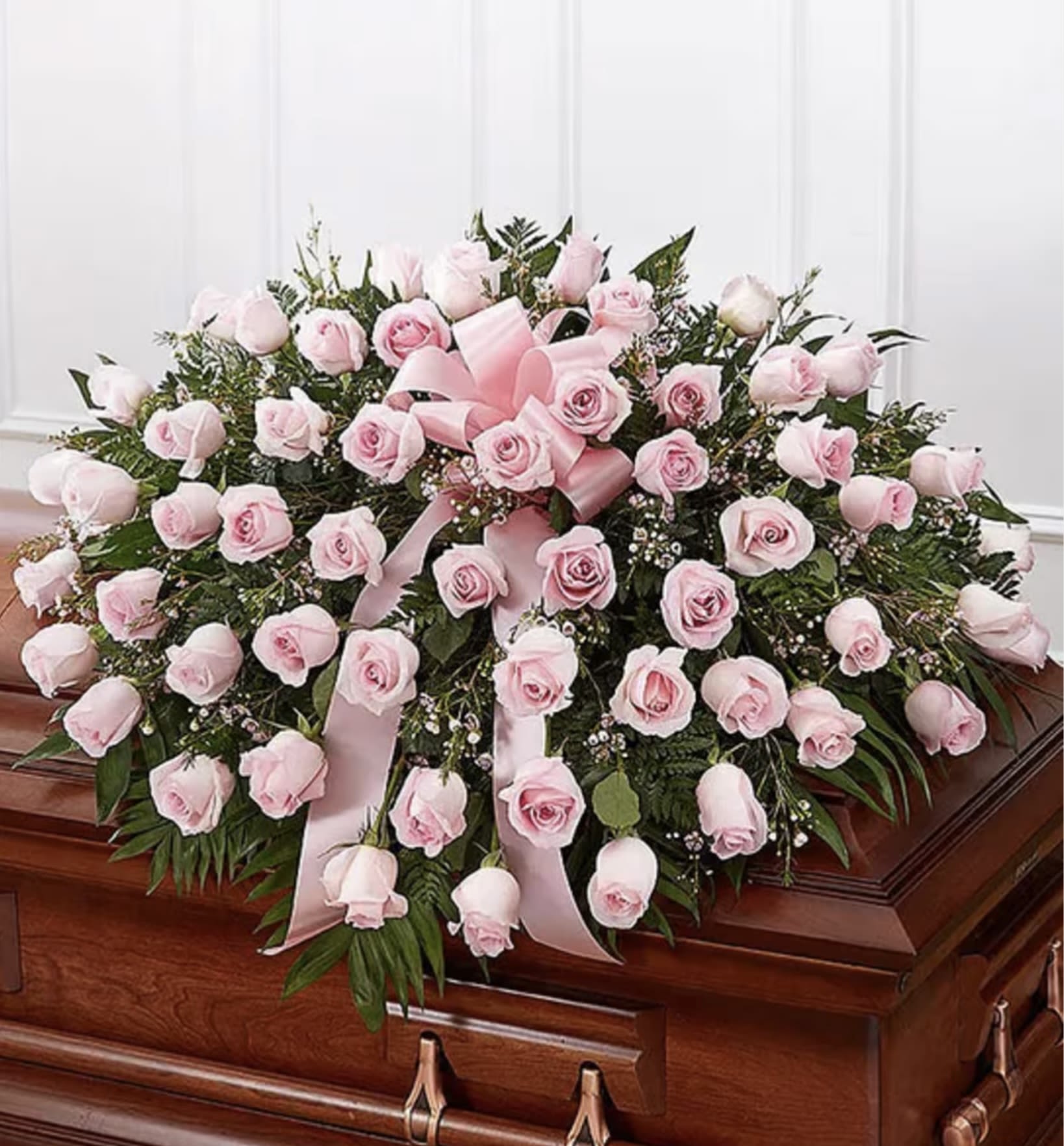 Pink memories  - A Gentle Farewell with Grace   Presenting our Elegant Pink Rose Casket Spray – a soft and serene tribute crafted with delicate pink roses, lush greenery, and a tender pink satin bow. This arrangement symbolizes grace, love, and cherished memories, offering a heartfelt way to honor a loved one’s journey.   Features: 	•	Premium pastel pink roses 	•	Enhanced with soft greenery and baby’s breath 	•	Meticulously designed for a touching goodbye  Perfect for expressing tenderness and admiration during a difficult time. Let us help you convey your love with this timeless floral tribute. Contact us for customization today.