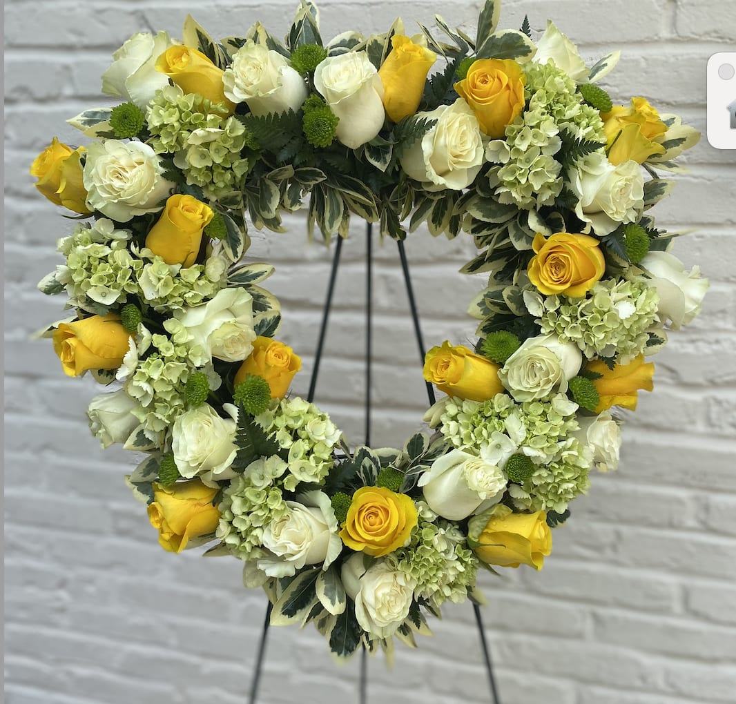 Loving Heart Standing Spray - The fragrant yellow, white and green of this beautiful standing spray – created in the shape of a heart – will express your deepest love and devotion to all in attendance.