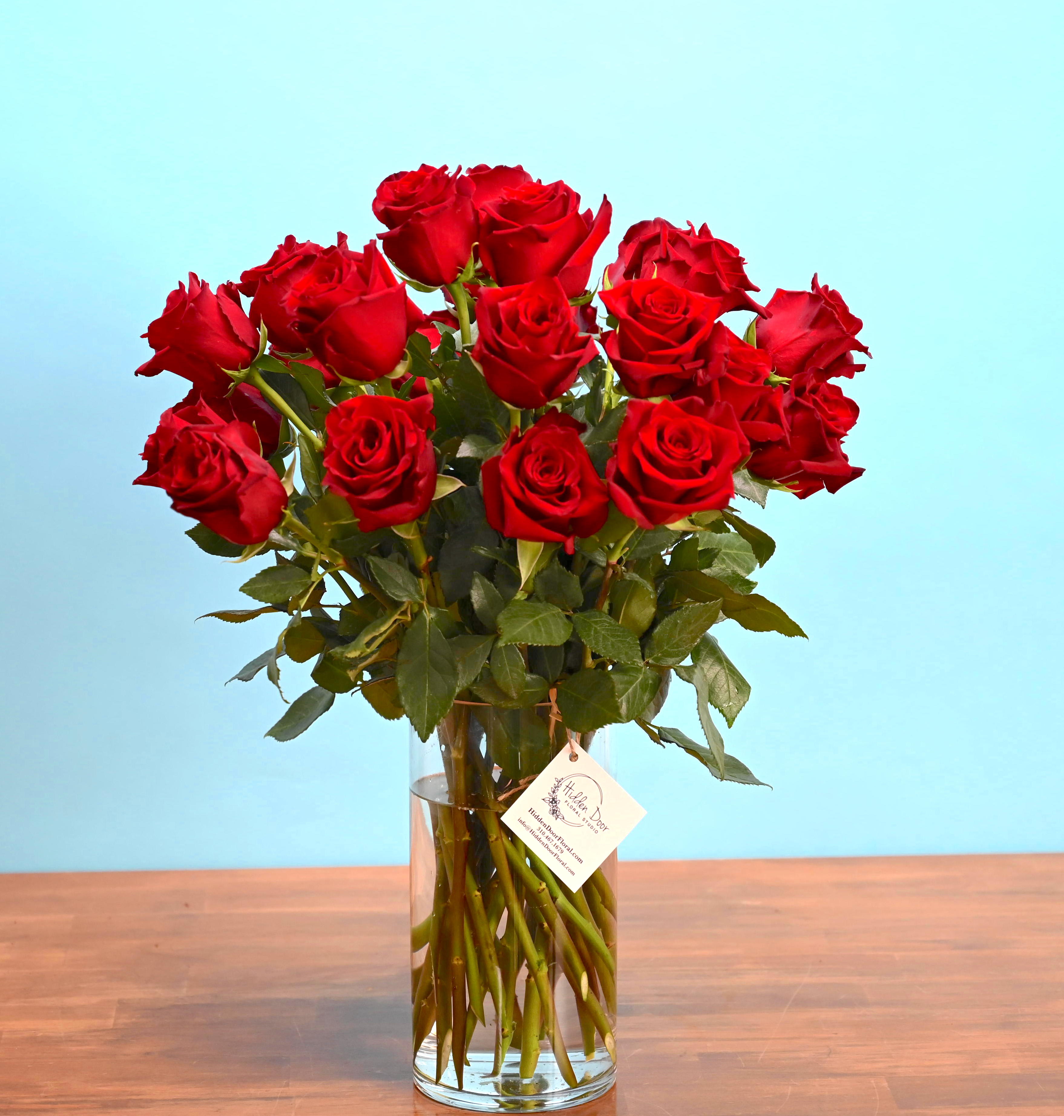 Tango Tango - The red roses in "Tango" are handpicked for their vibrant colors and velvety petals, ensuring that each bloom is a masterpiece. With a delightful mix of rich hues and delicate fragrances, these roses exude a sense of passion and romance, making them the perfect floral gift for someone special or a charming addition to your space. At Hidden Door Floral Studio, we believe in going above and beyond to create unforgettable floral experiences. Our skilled designers pour their heart and soul into every floral arrangement, infusing it with creativity, love, and a touch of magic. "Tango" is no exception -it reflects our commitment to floral excellence and dedication to bringing beauty and joy to your life through the beauty of flowers.