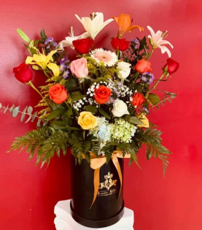 CYLINDER COLORFUL DESIGN CYLINDER TALL BOX CYLINDER COLORFUL DESIGN CYLINDER TALL BOX - 18 roses with Lily's, hydrangea and flower components with green foliage