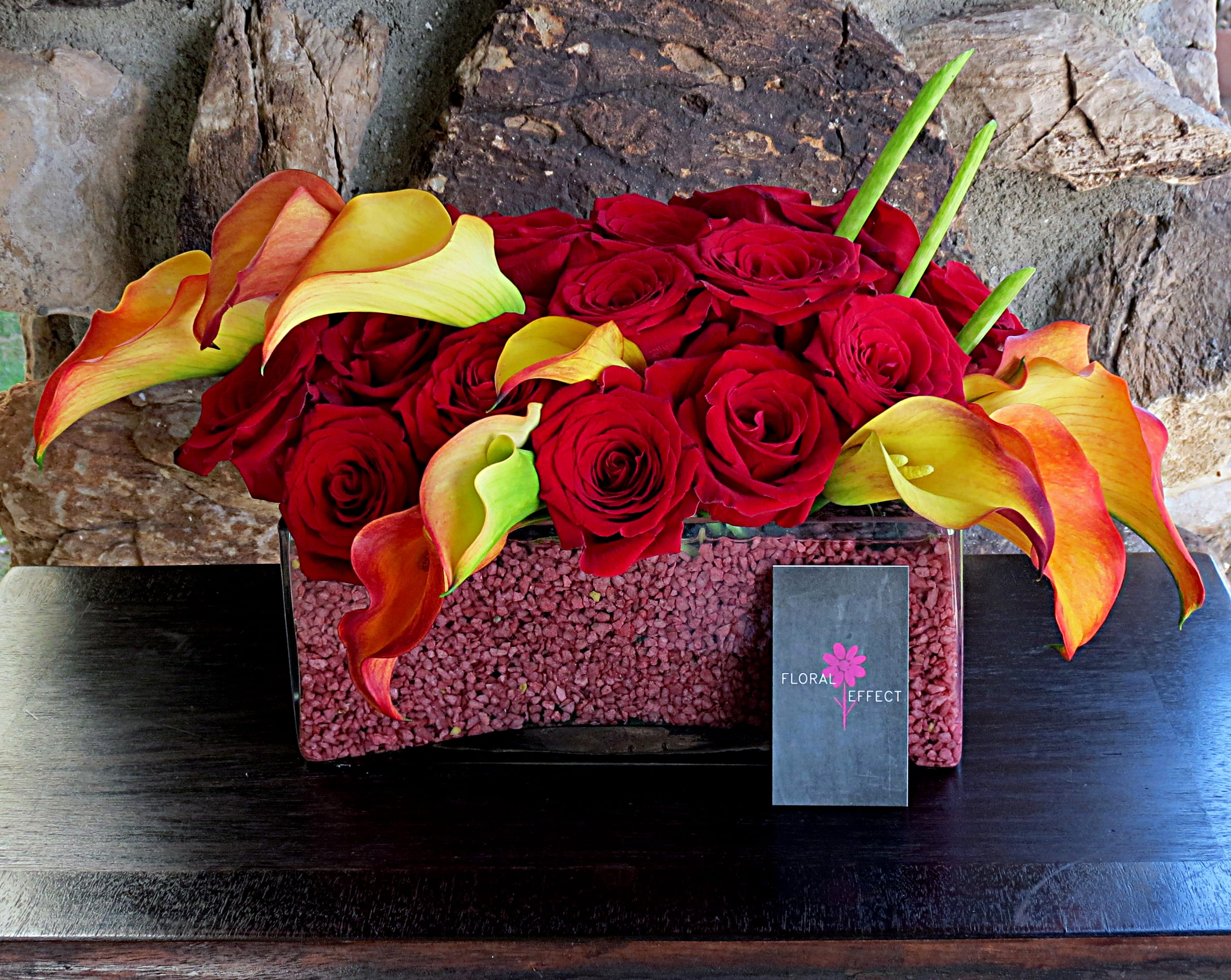 Red Roses and Mango Callalilies Red Roses and Mango Callalilies - Red roses and calla lilies arranged on a glass vase filled with red gravel.