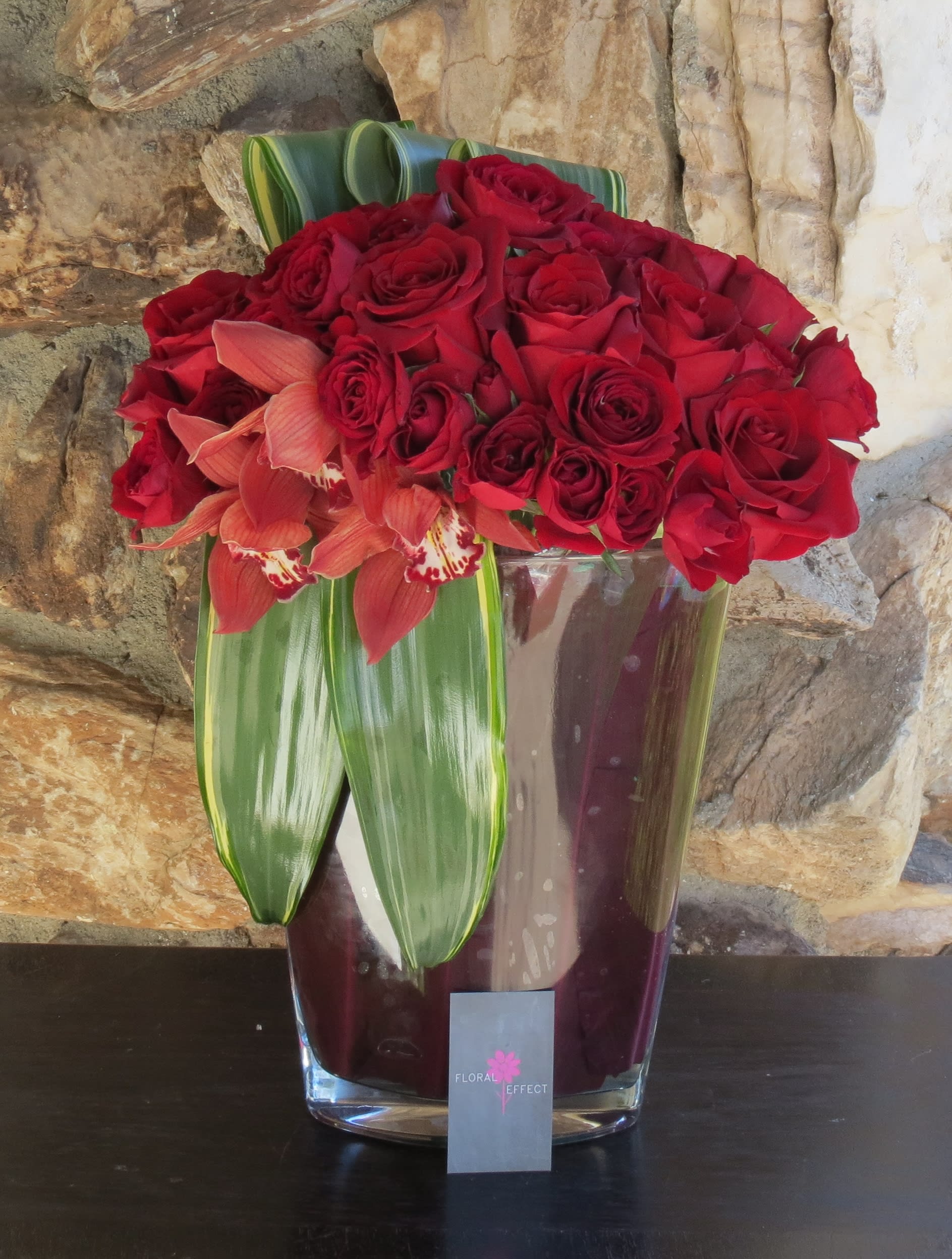 Red roses and Red cymbidiums - 50 Red roses and red cymbidiums arranged on a beautiful tall glass vase